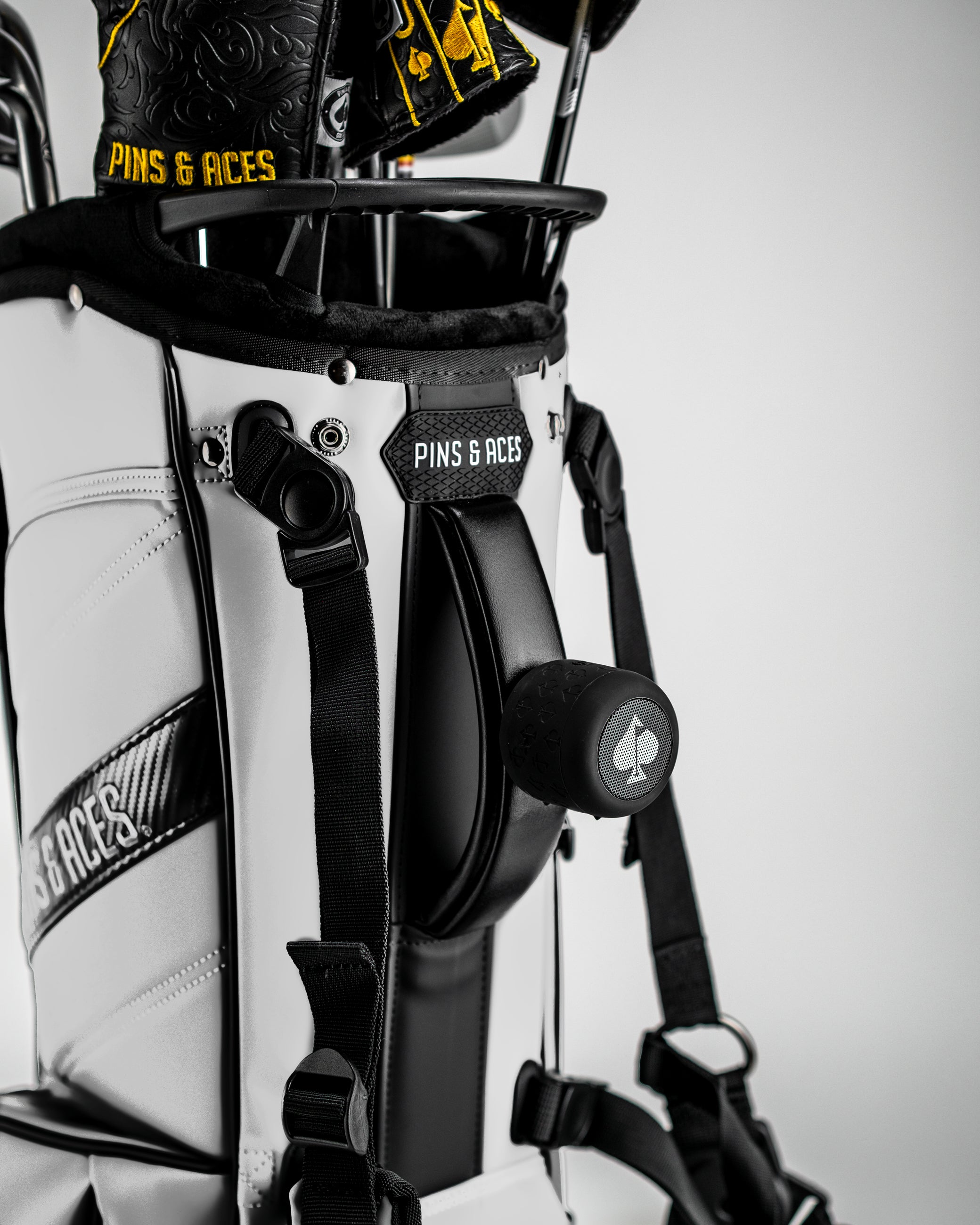 Player Preferred™ Golf Bag in Domino design, showcasing a stylish white exterior with a modern pattern and integrated speaker.