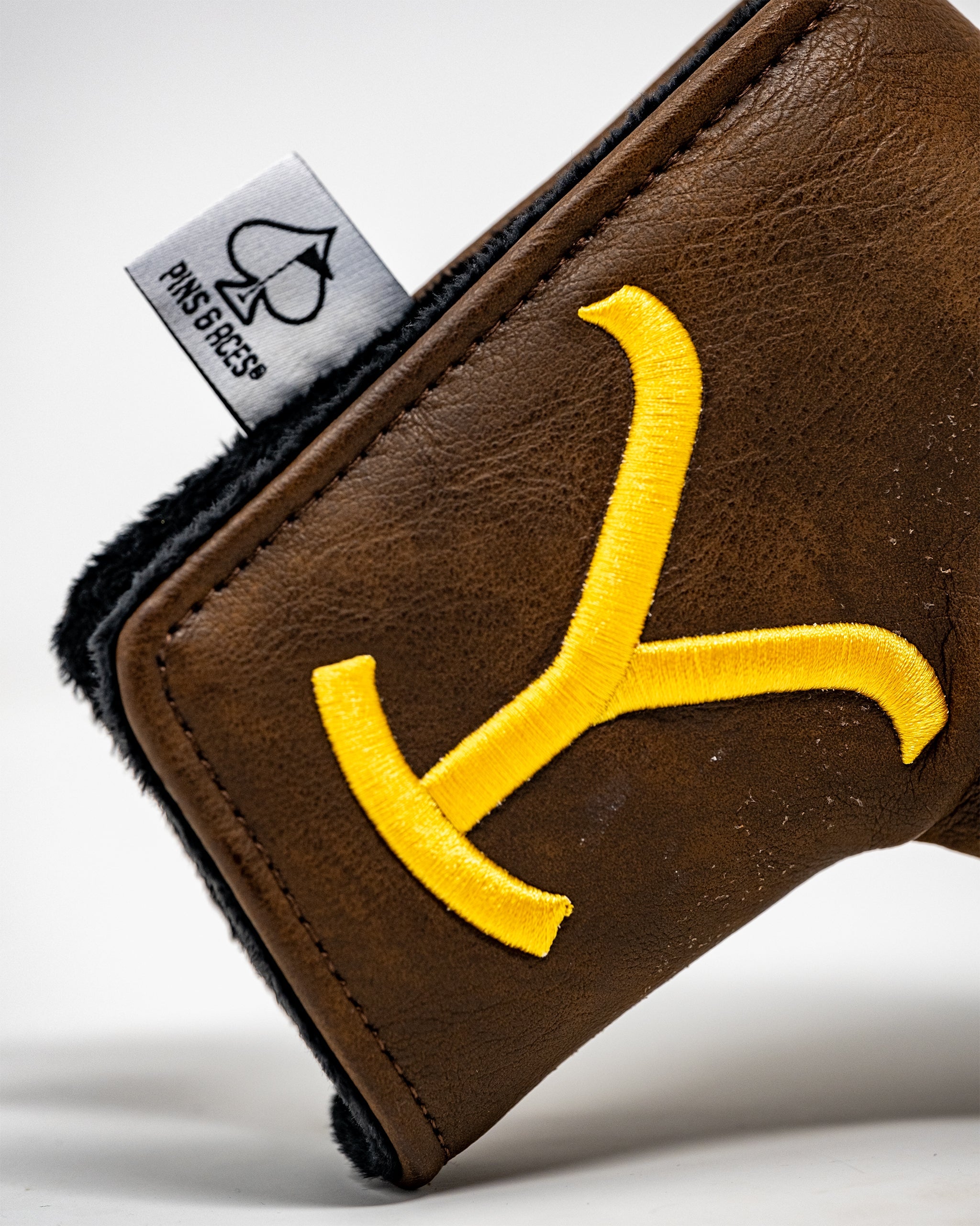 Yellowstone Blade Putter Cover featuring a vibrant design and durable material, showcasing a snug fit for protecting golf putters.