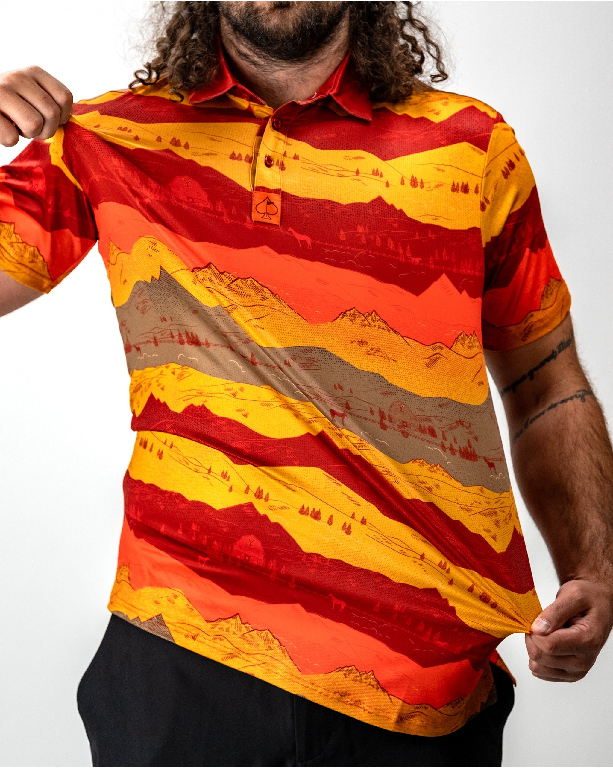 Stunning sunset over Yellowstone National Park, showcasing vibrant orange and purple skies above silhouetted mountains and trees.