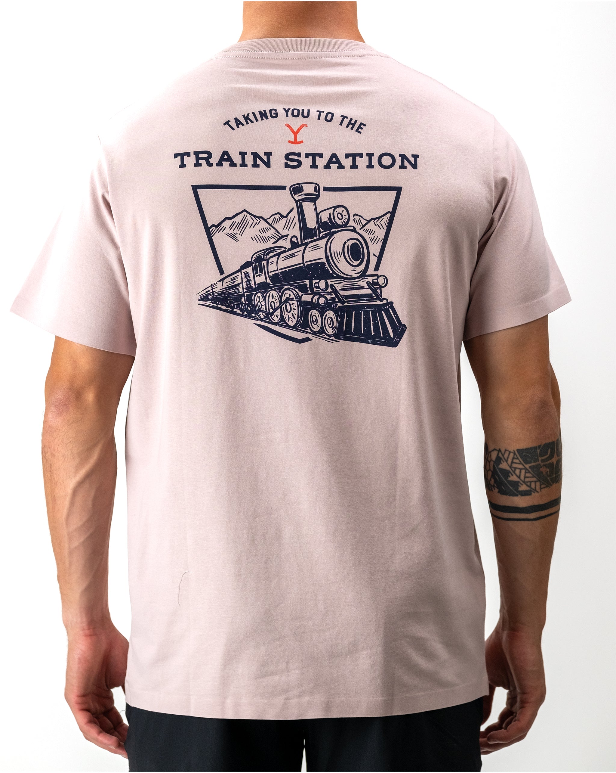 "Yellowstone Train Station tee featuring a vintage-inspired graphic design of a scenic train station silhouette against a sunset backdrop."