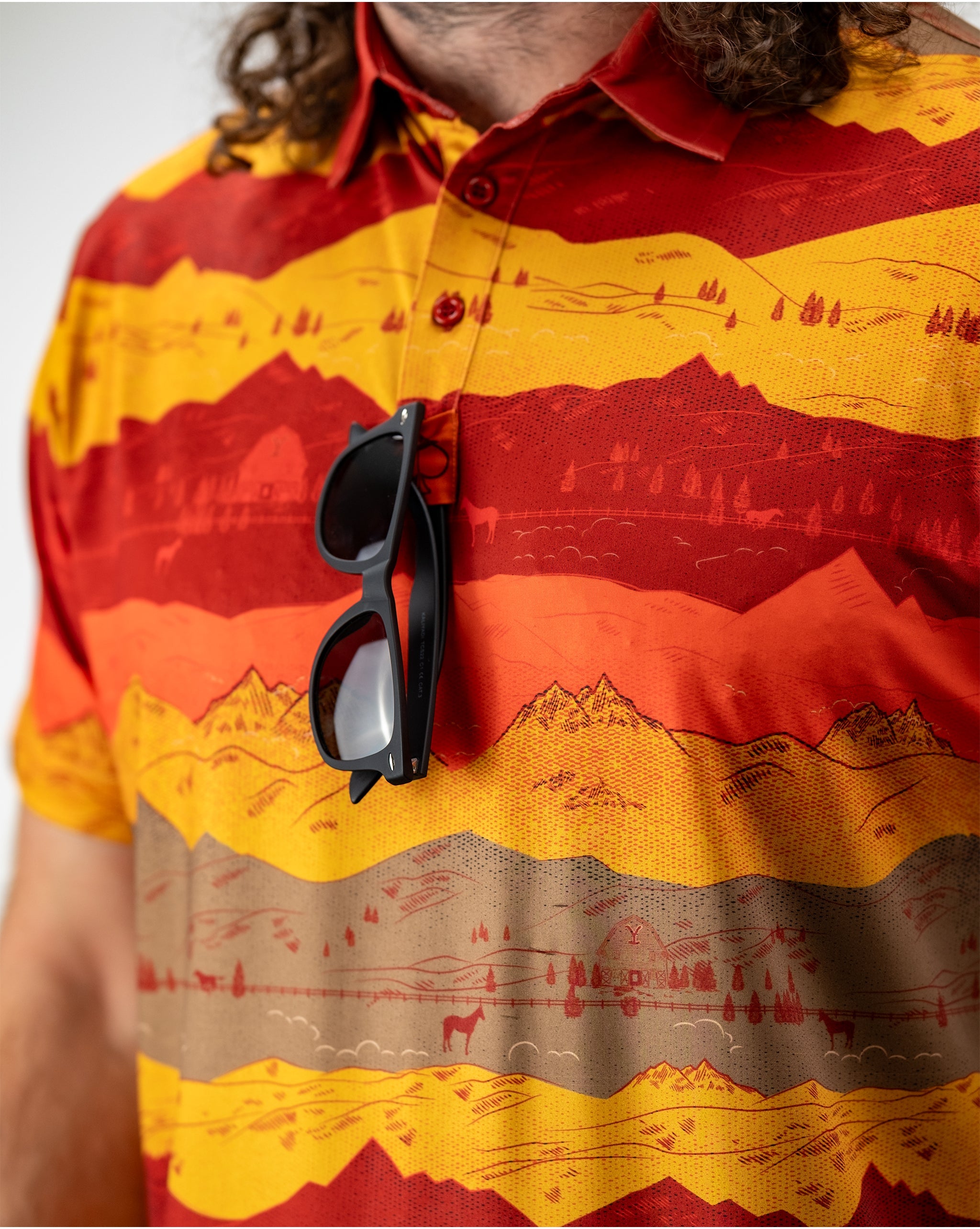 Breathtaking sunset over Yellowstone National Park, showcasing vibrant orange and purple hues in the sky, silhouetted mountains, and serene natural landscape.