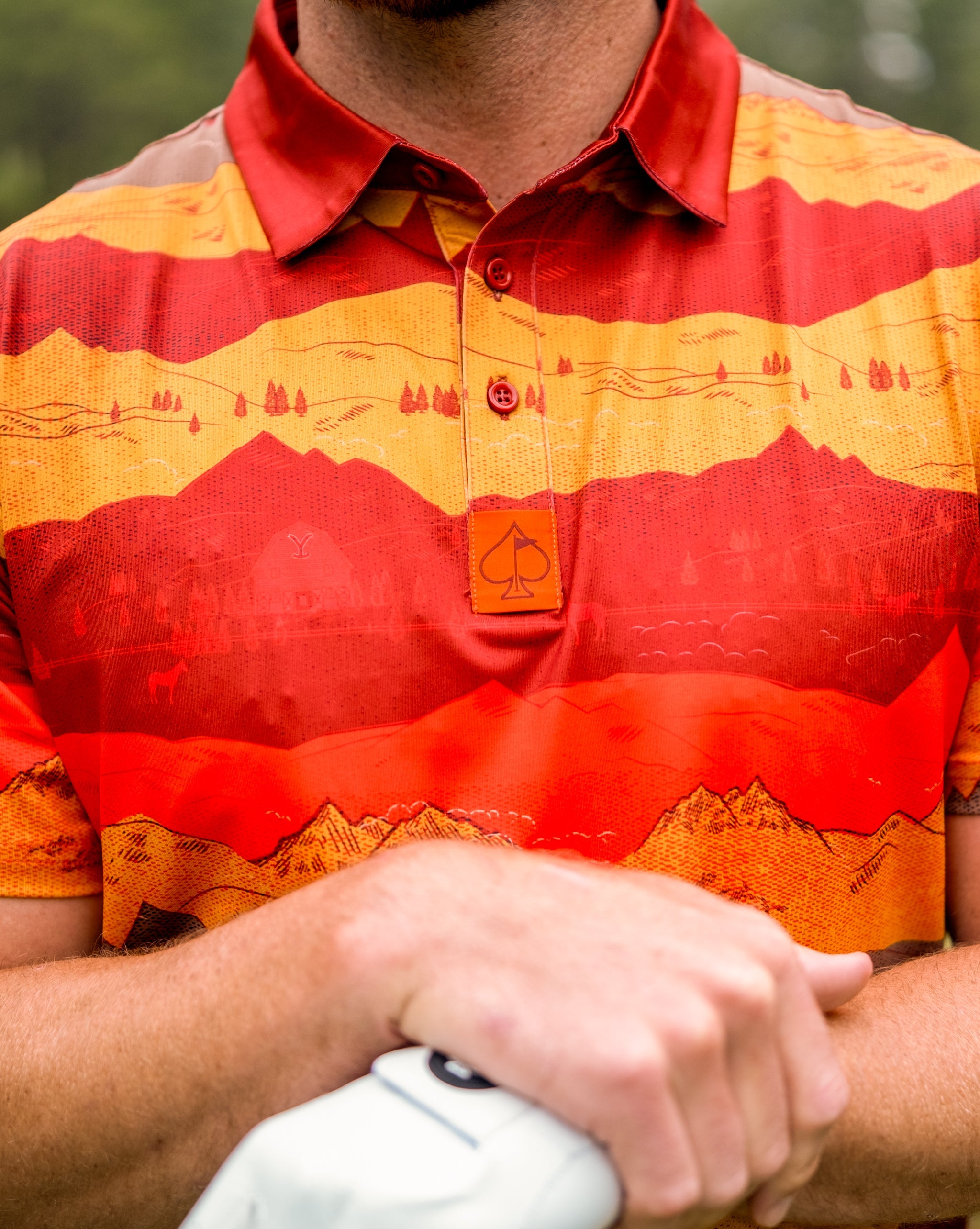 Yellowstone National Park sunset with vibrant orange and purple skies over sweeping landscapes and silhouetted mountains.