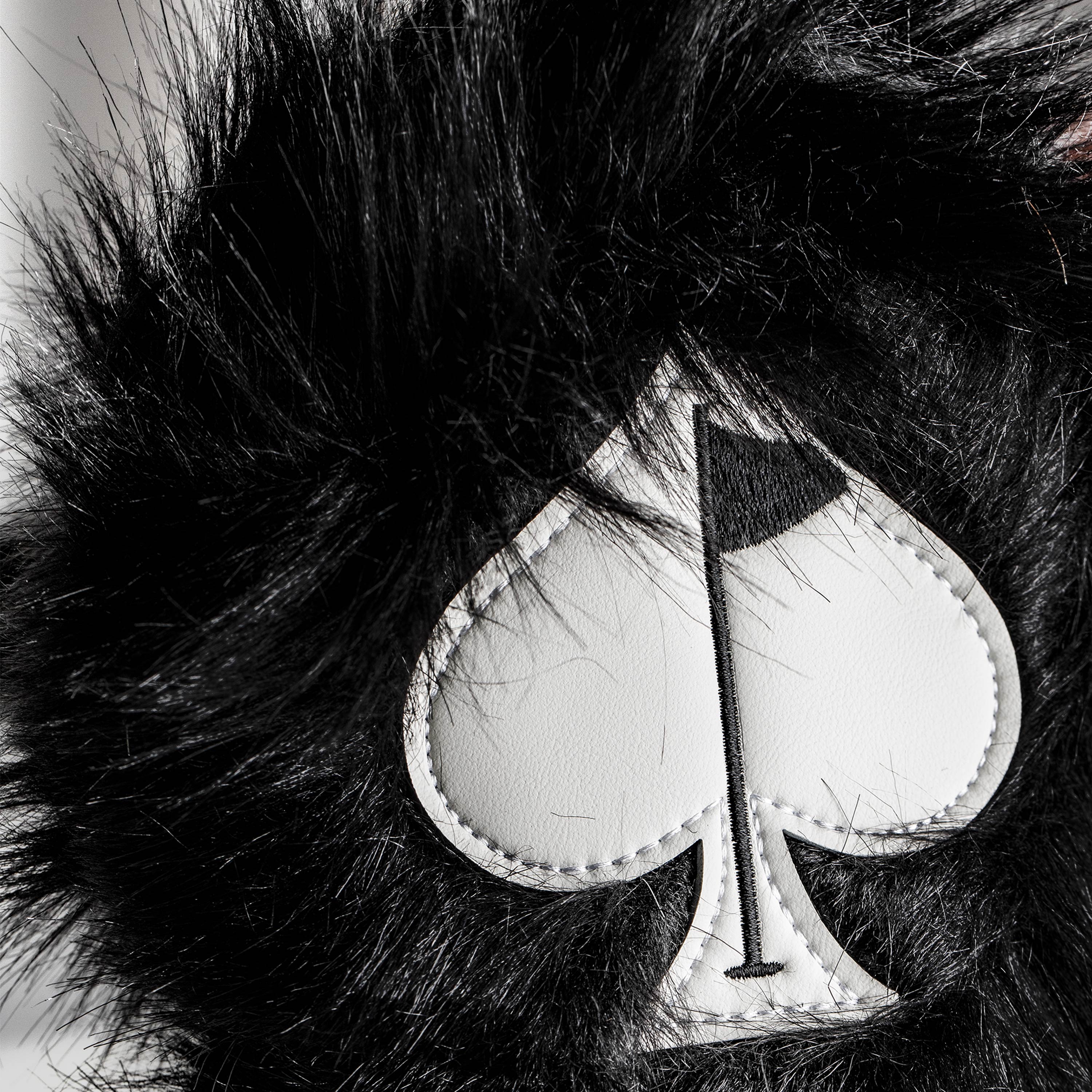 Black fuzzy driver cover for golf club, featuring a sleek design and soft texture.