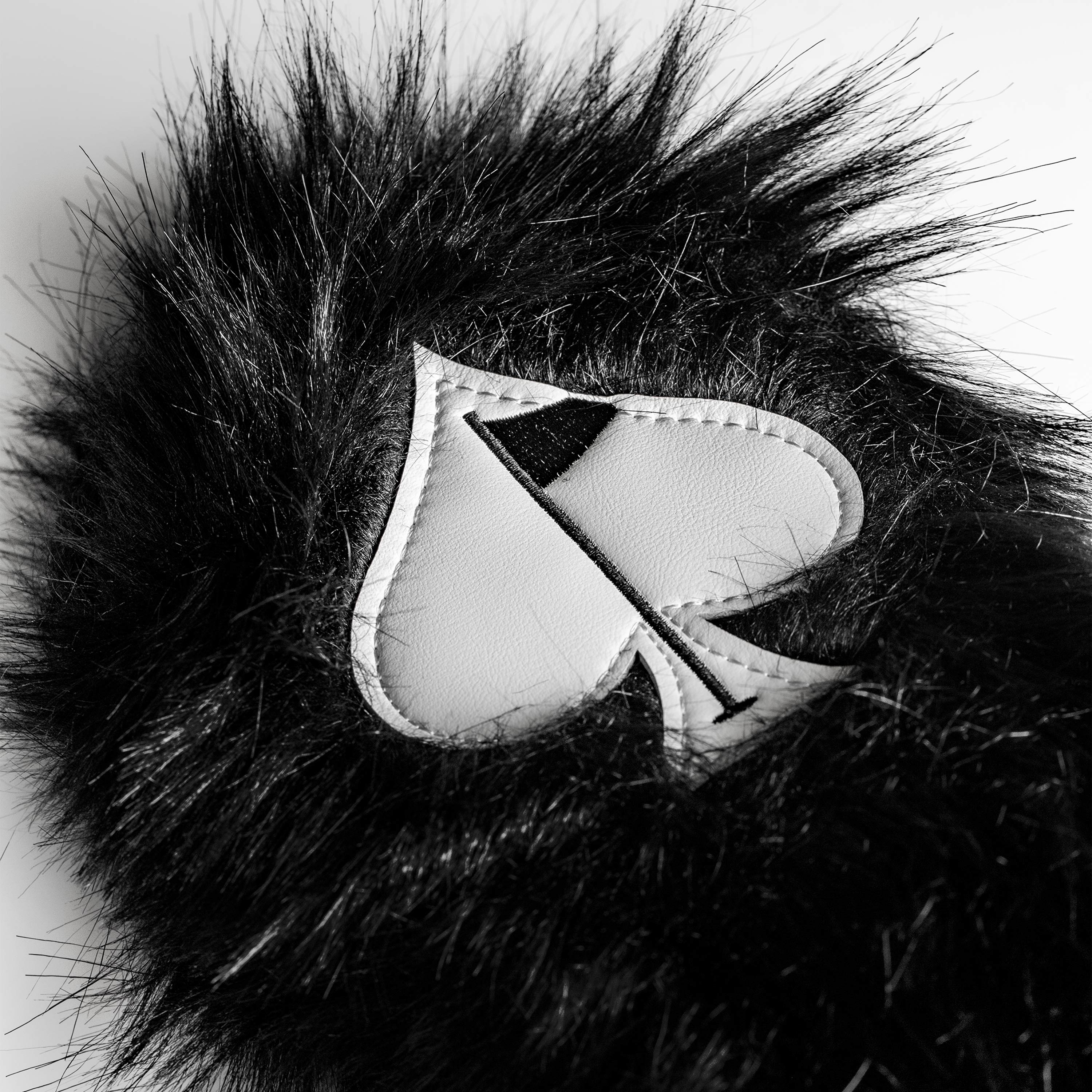 Black fuzzy driver cover for golf clubs, featuring a soft texture and stylish design.