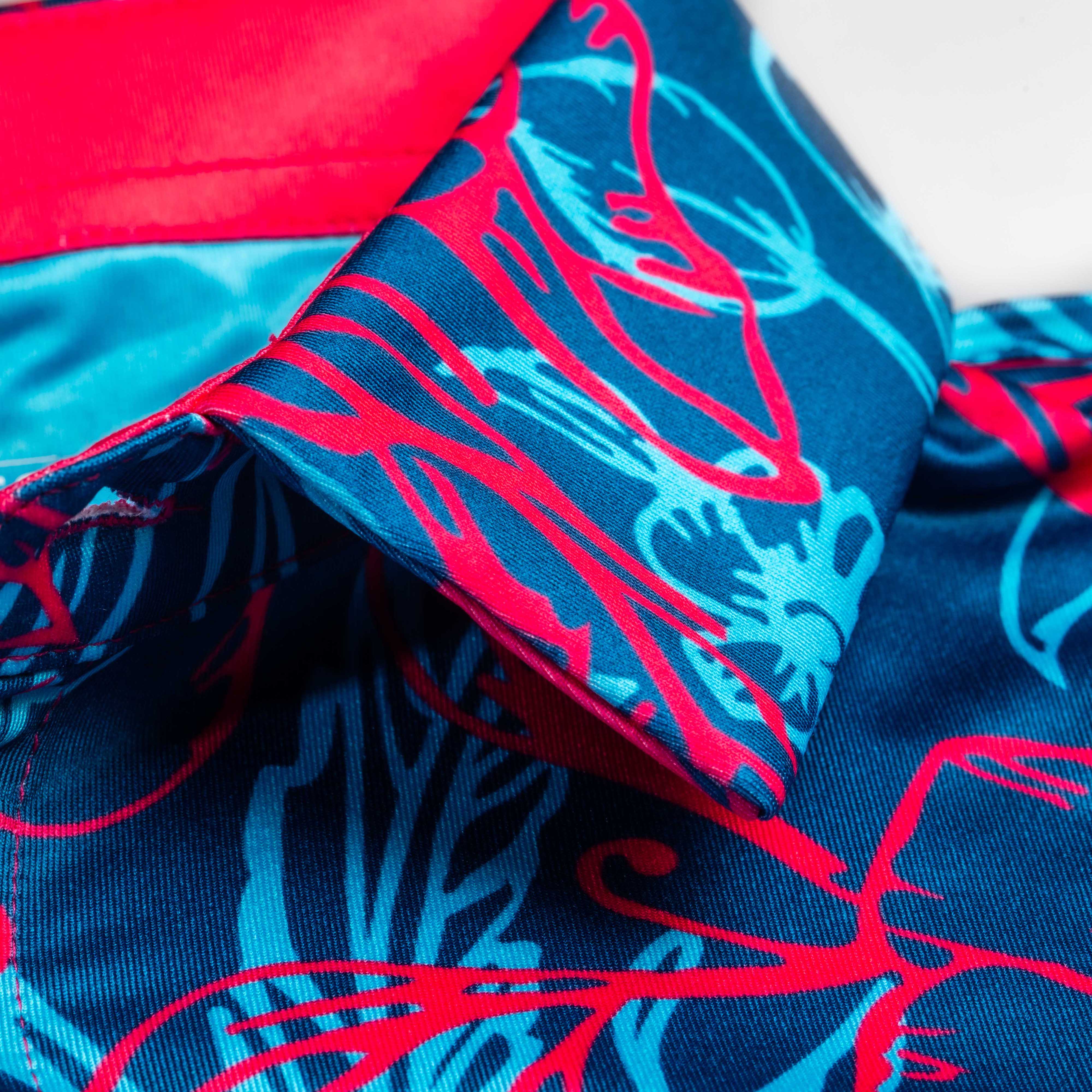 Cabo Colada blue and magenta Hawaiian polo shirt with vibrant tropical print.
