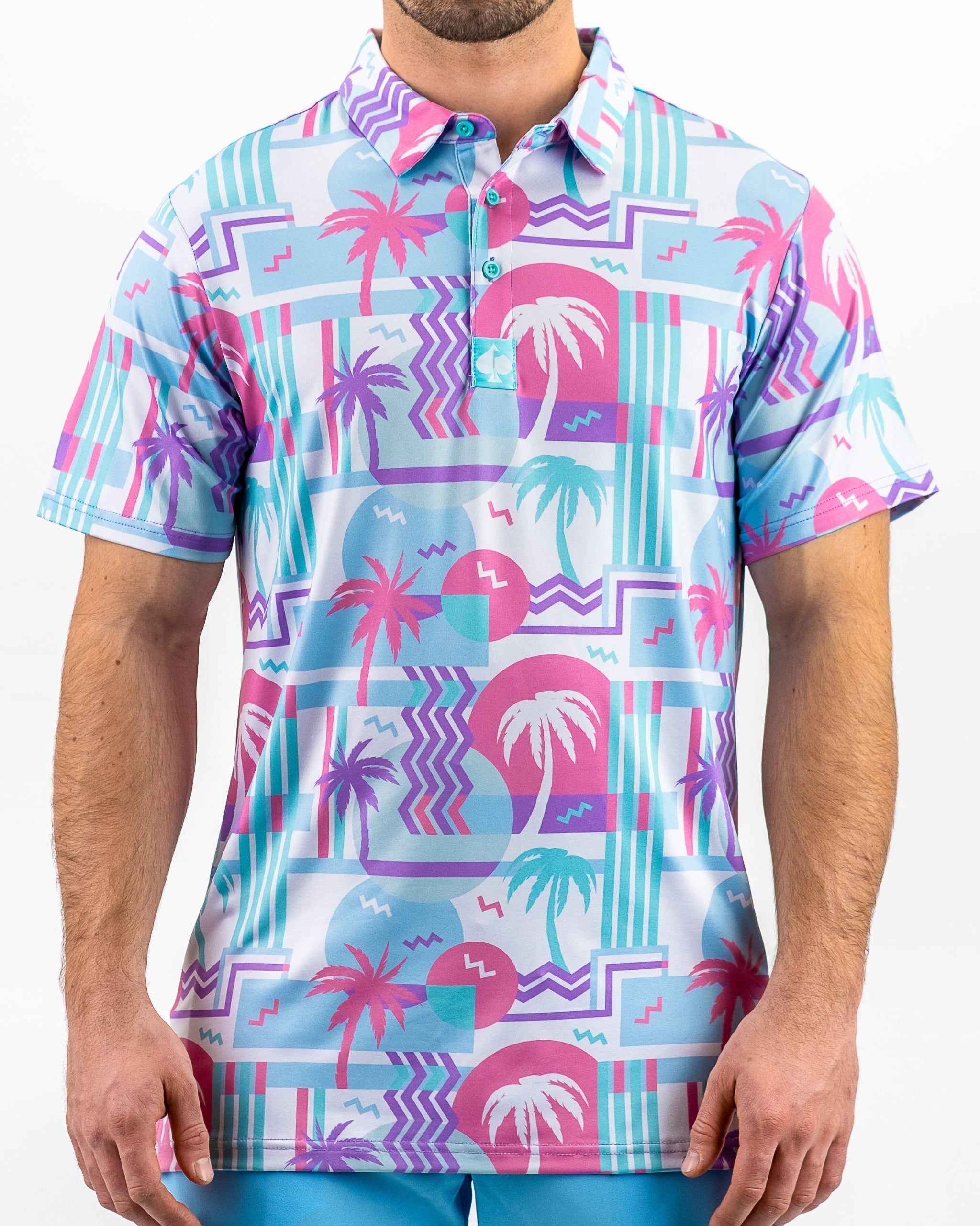 Colorful golf polo shirt featuring a vibrant beach-themed design with palm trees, waves, and geometric patterns.