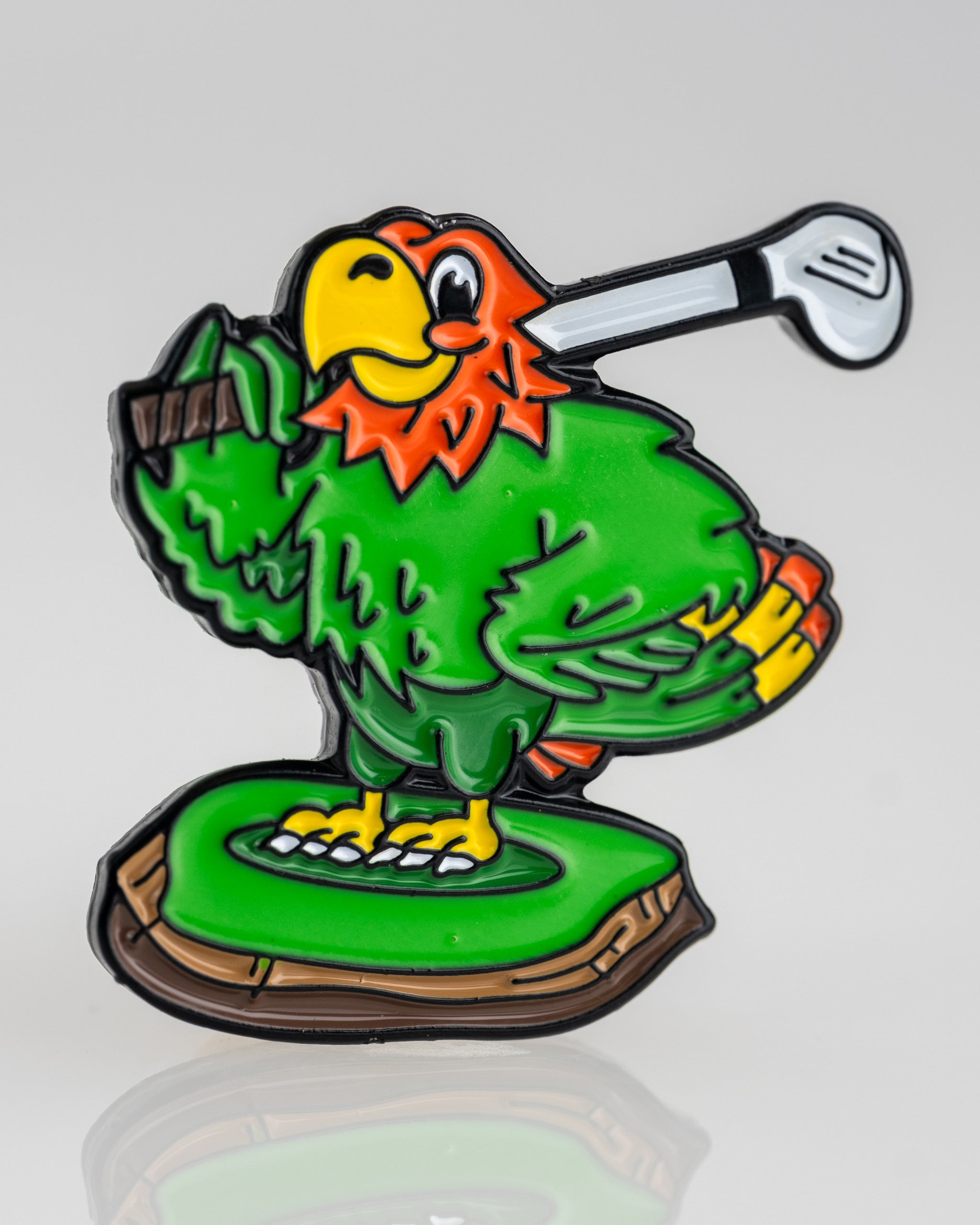 Colorful Margaritaville golfing parrot ball marker featuring a cartoon parrot holding a golf club on a tee.