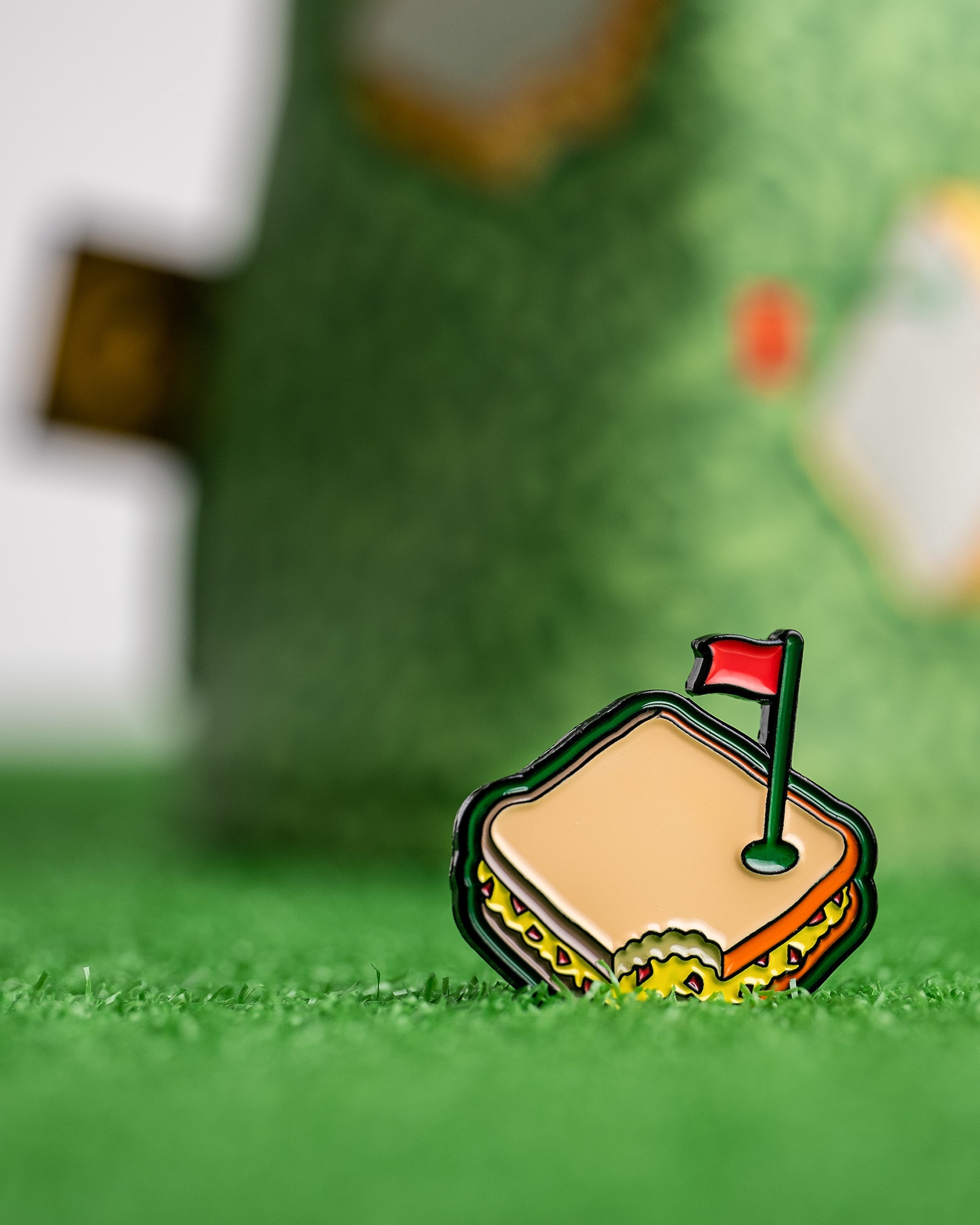 Colorful enamel golf course sandwich headcover with a red flag, perfect for bold golfers seeking unique accessories.