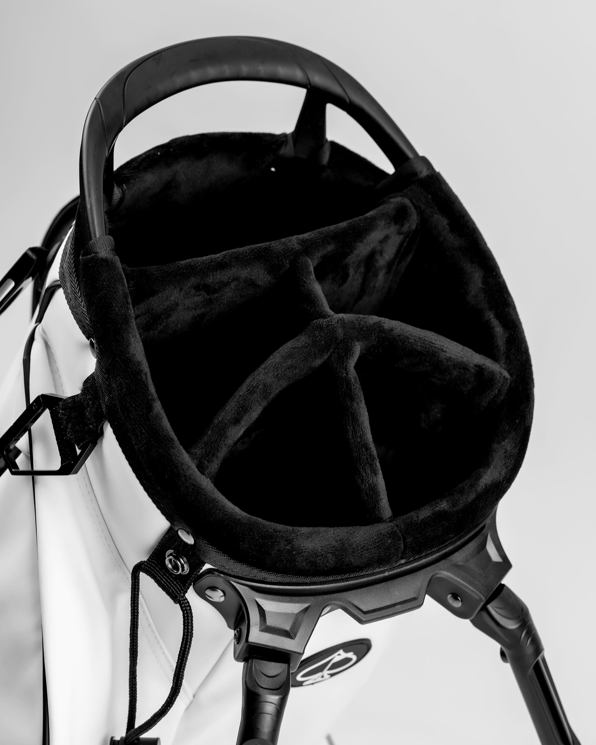 Top view of the Player Preferred Golf Bag in Domino, showcasing a plush, black-lined interior with organized compartments.