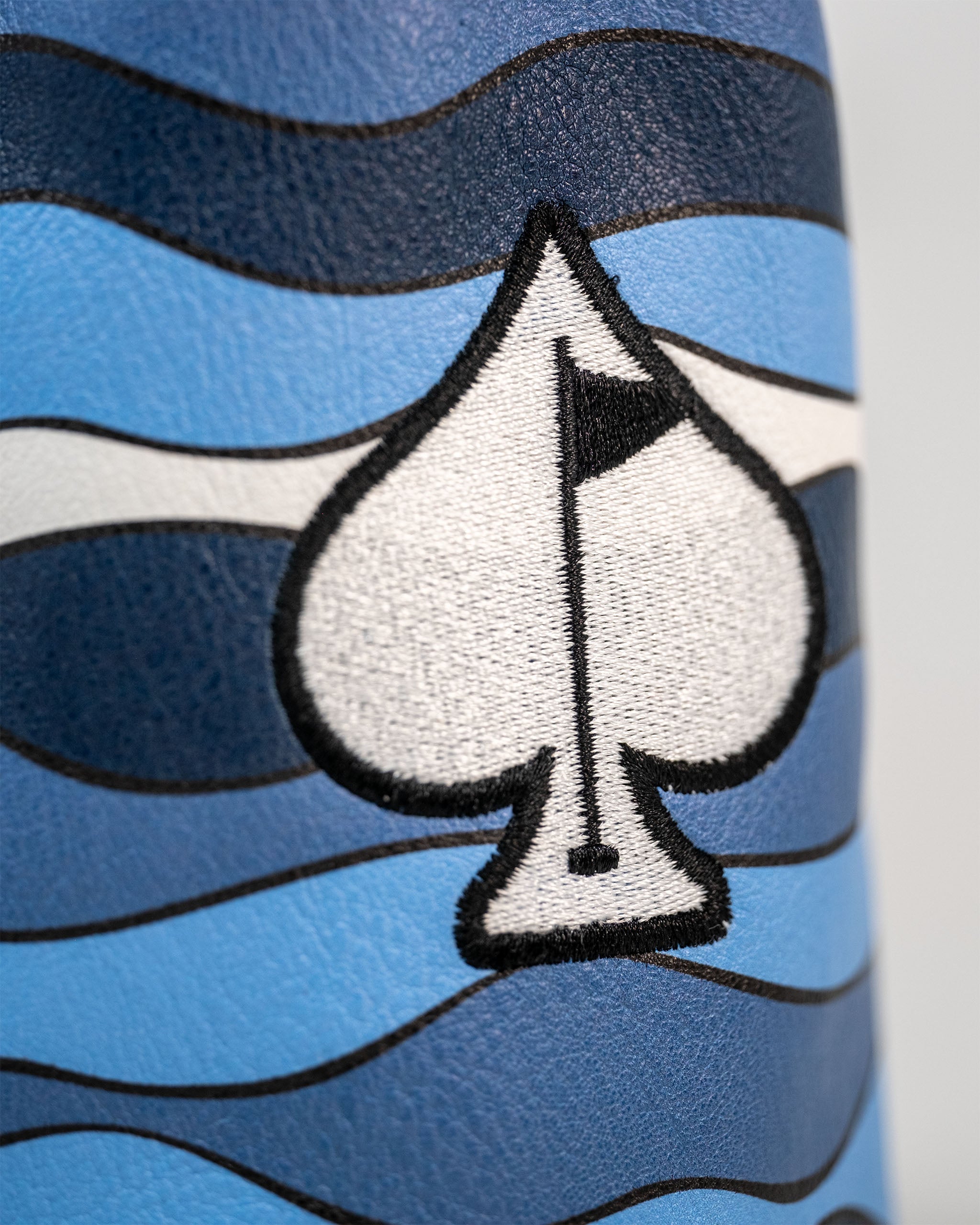 Bold Shark Attack driver cover featuring a blue wave design and a spade logo with a golf flag. Perfect for standout golfers.
