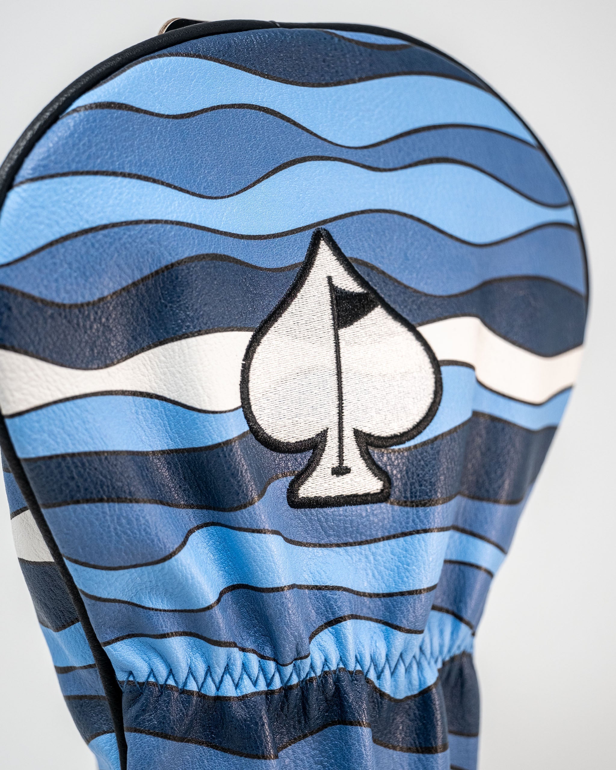 Bold Shark Attack driver cover featuring blue wave patterns and a spade logo, perfect for golfers wanting to stand out.