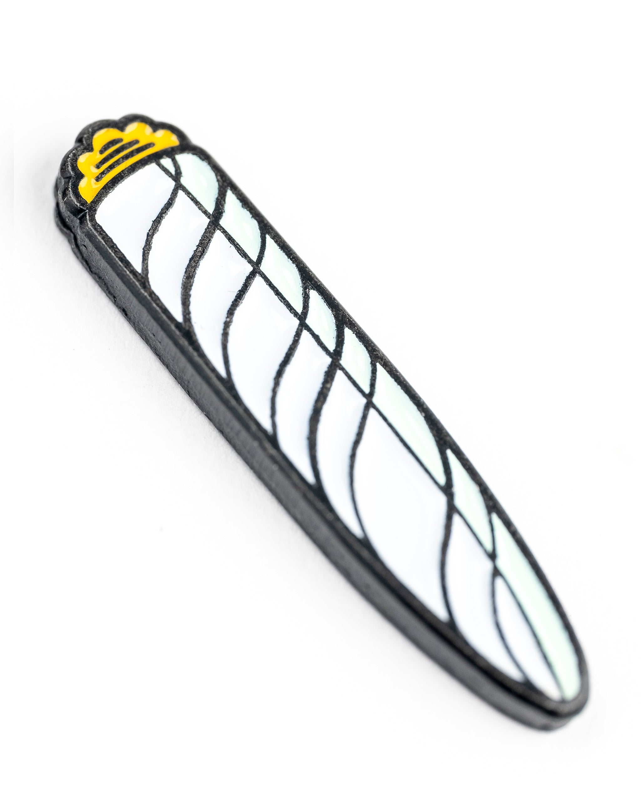 Alt text: "Close-up of a 420 joint-themed golf ball marker, designed to resemble a cannabis joint with a yellow crown on top and detailed netting pattern."