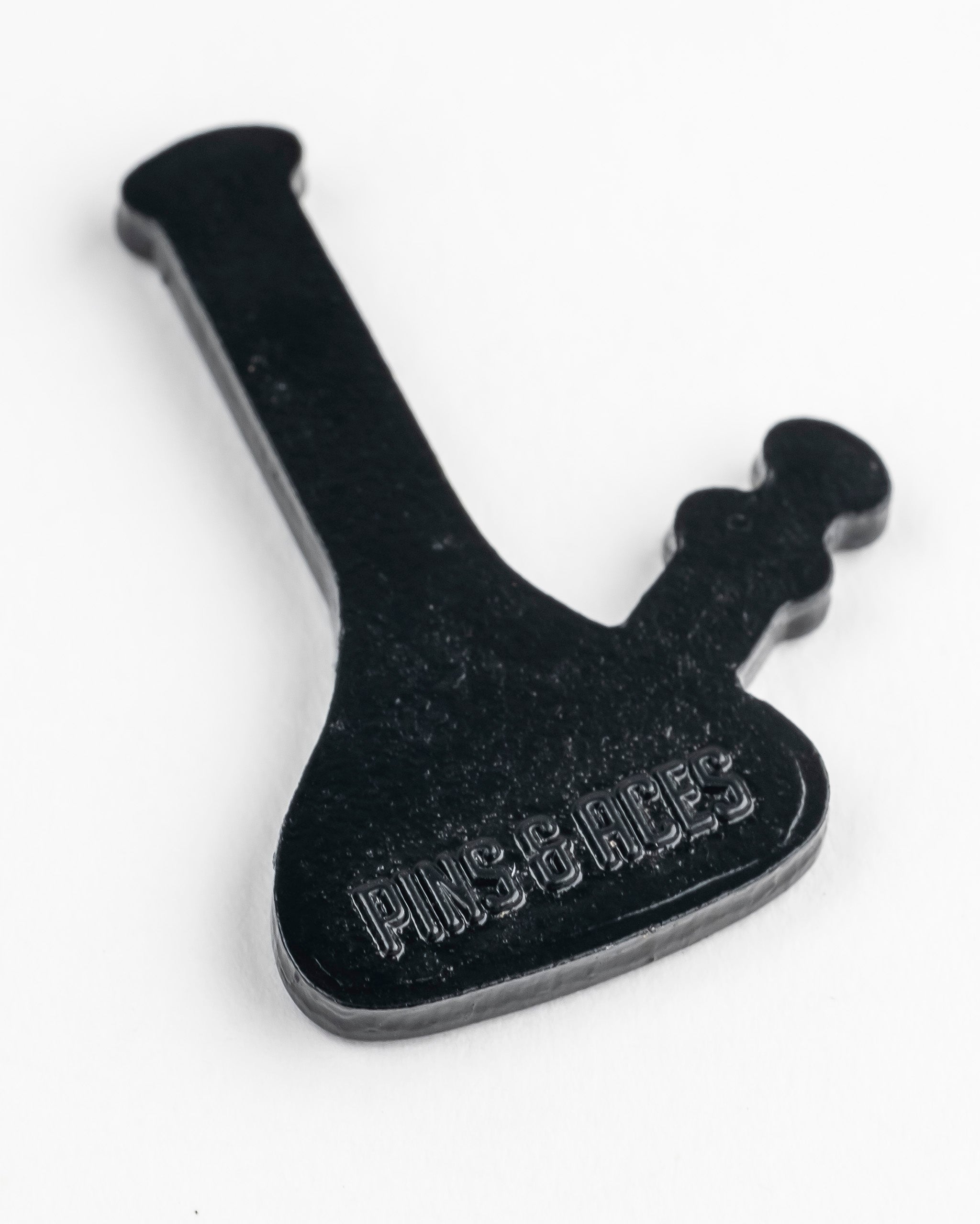 Alt text: Black metal golf ball marker shaped like a bong with the inscription "Pins & Aces" on a white background.