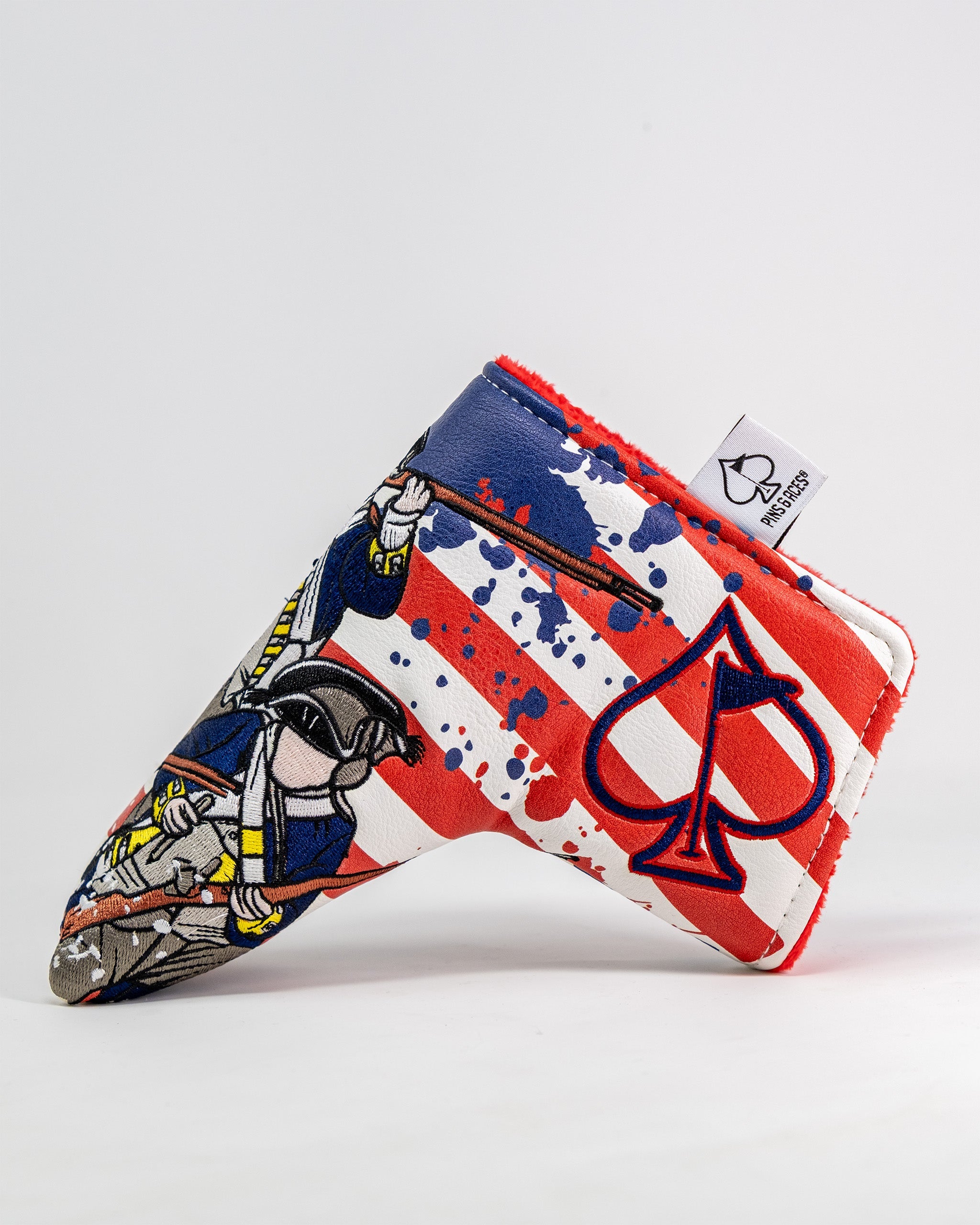 Golf blade putter cover featuring a patriotic red, white, and blue design with a cartoon character and spade logo.