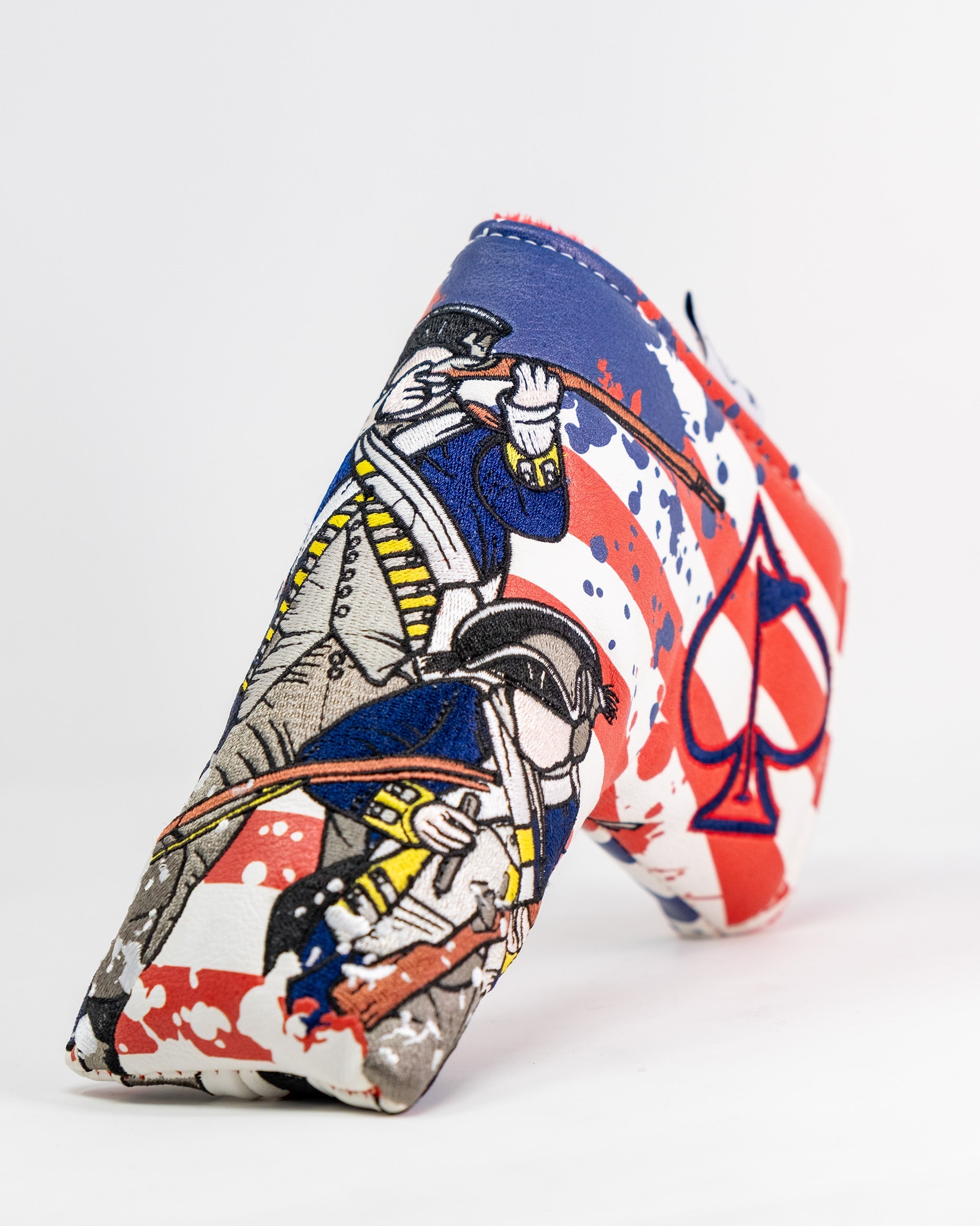Colorful blade putter cover featuring a pirate illustration and spade design, with red, white, blue, and yellow accents.