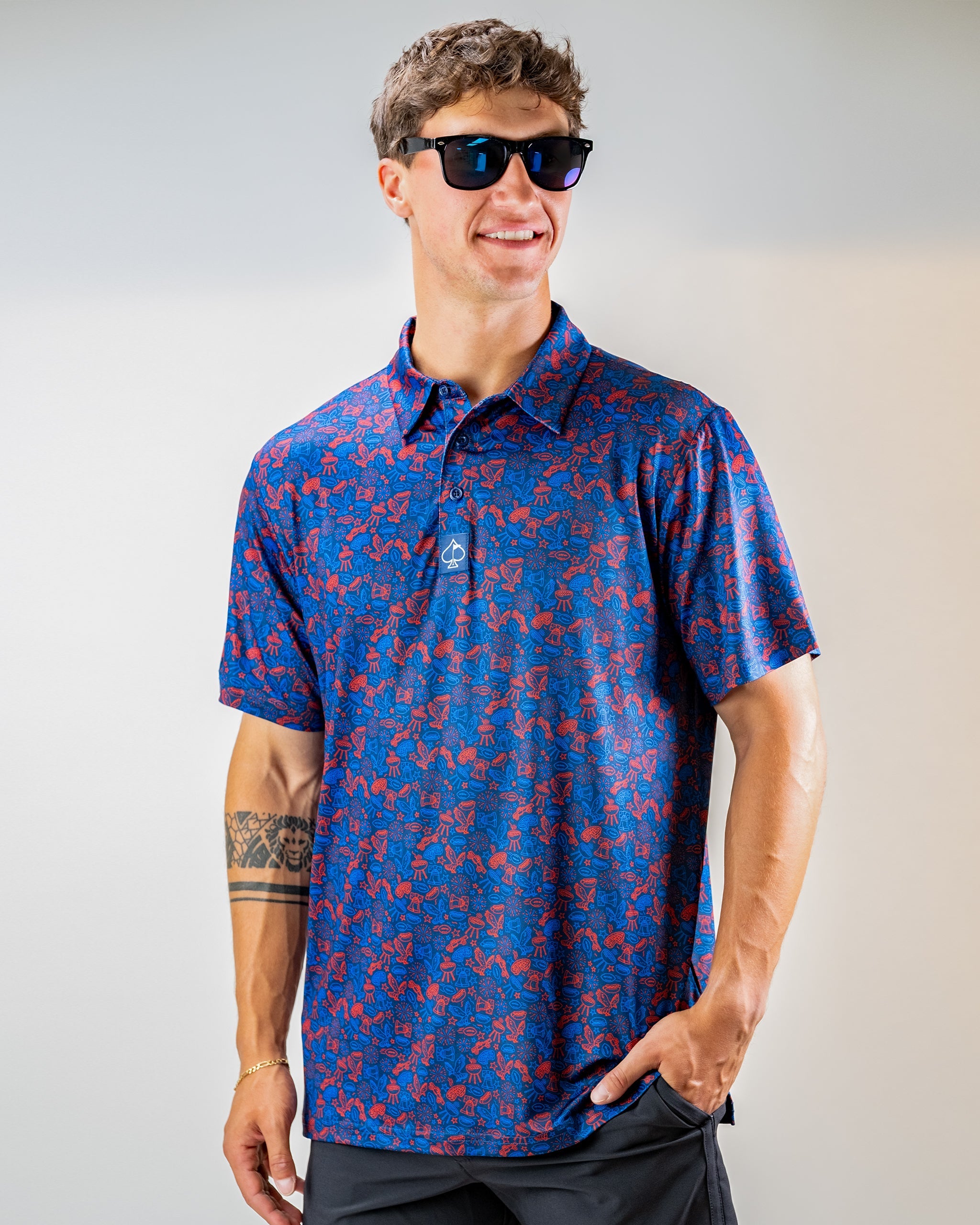 Navy golf polo featuring a vibrant doodle pattern in red, designed for a stylish and bold look on the course.