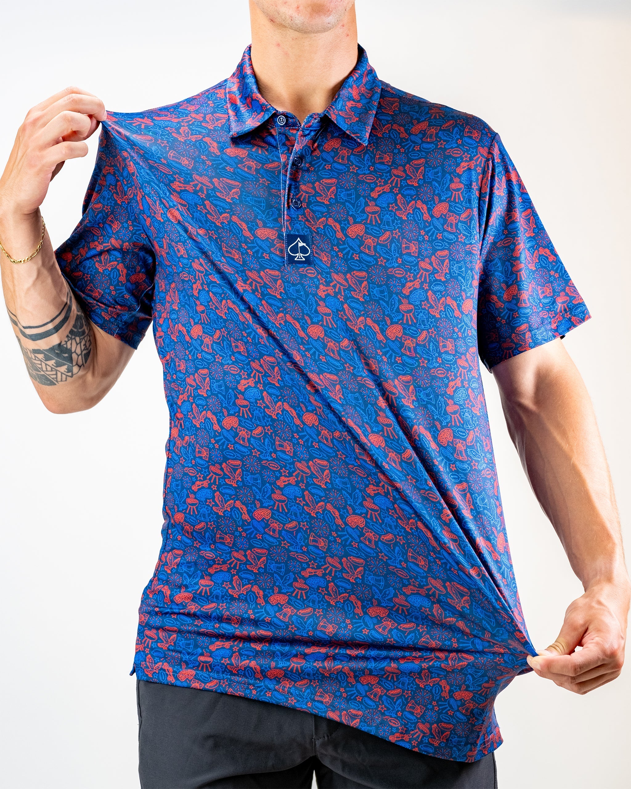 Navy polo shirt featuring a vibrant red doodle pattern, modeled by a person pulling the fabric to showcase its design.