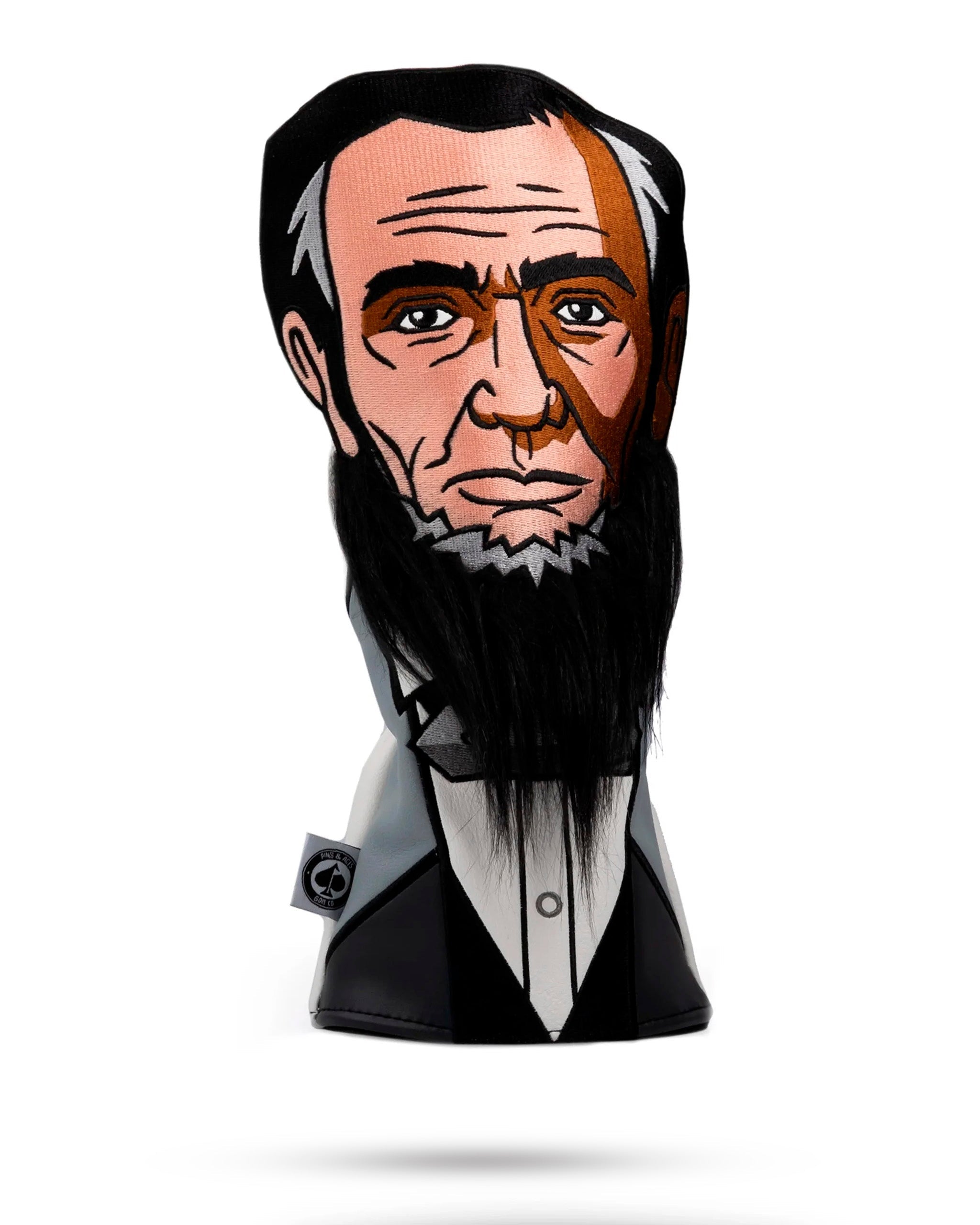 Alt text: "Abe Lincoln themed golf driver cover featuring a detailed caricature of Abraham Lincoln with a striking facial expression, dressed in a suit, isolated on a white background."
