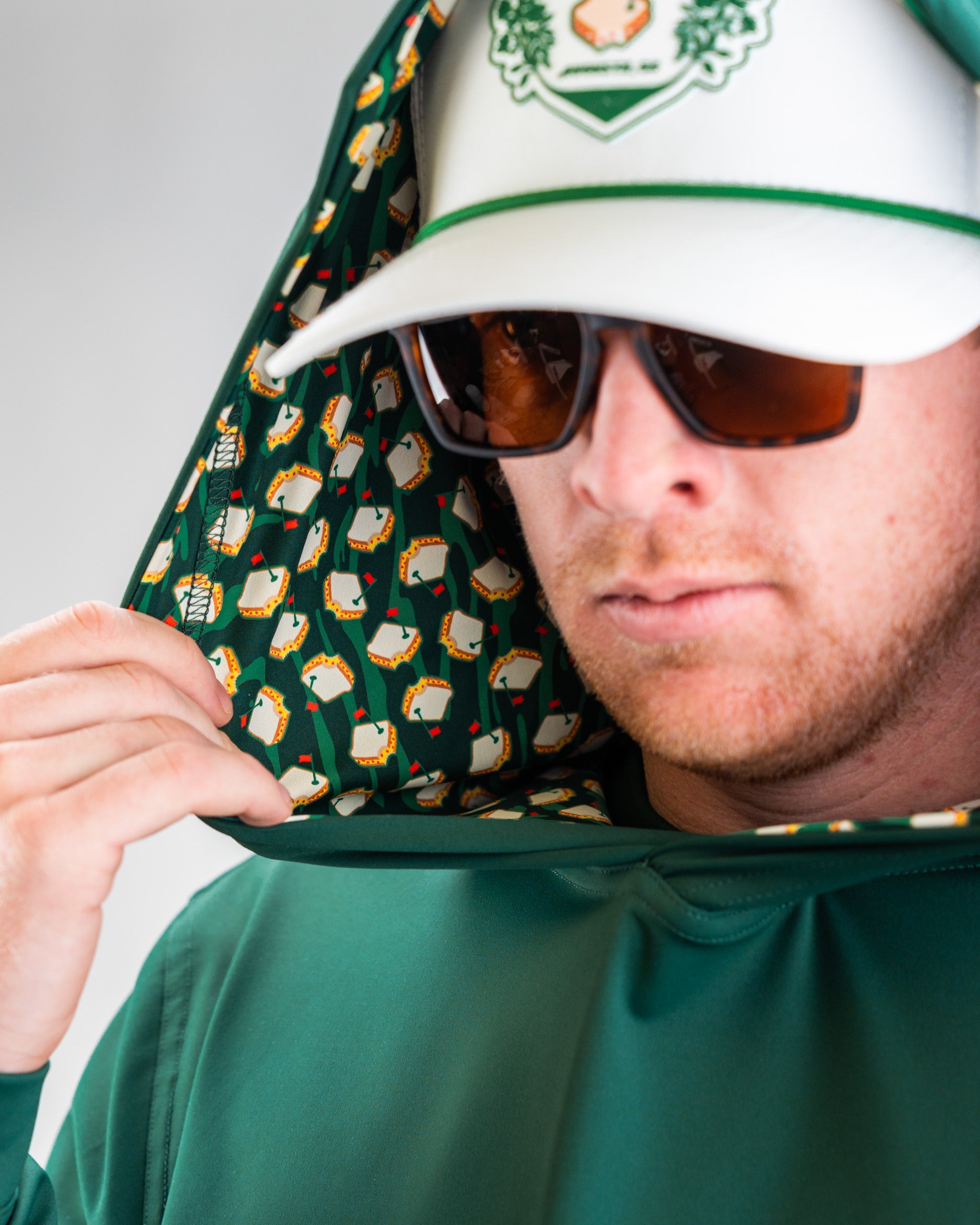 Red performance golf hoodie featuring a sleek design with a front pocket and hood, perfect for athletic wear.