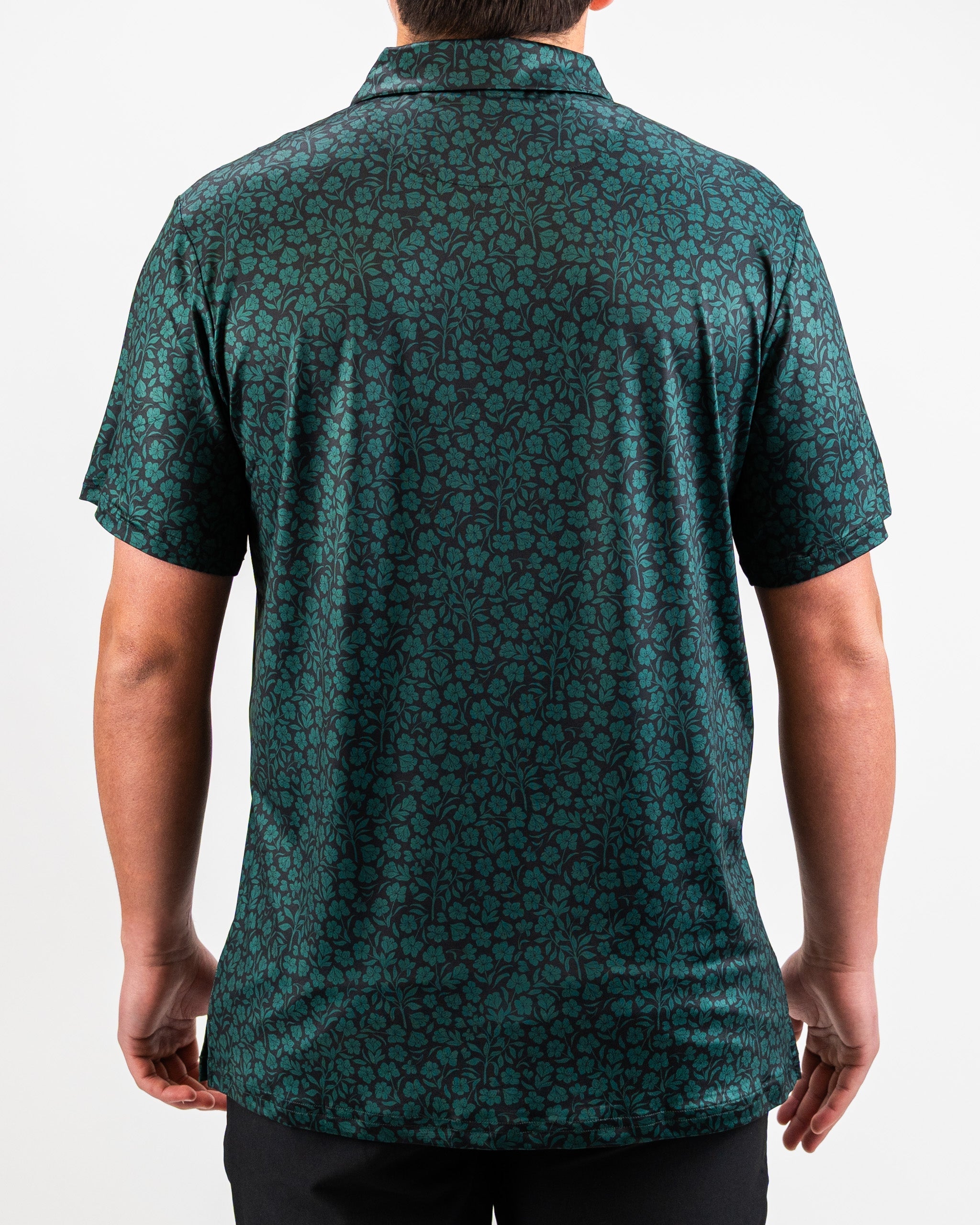 Hibiscus green blouse with a vibrant floral pattern, featuring short sleeves and a relaxed fit.