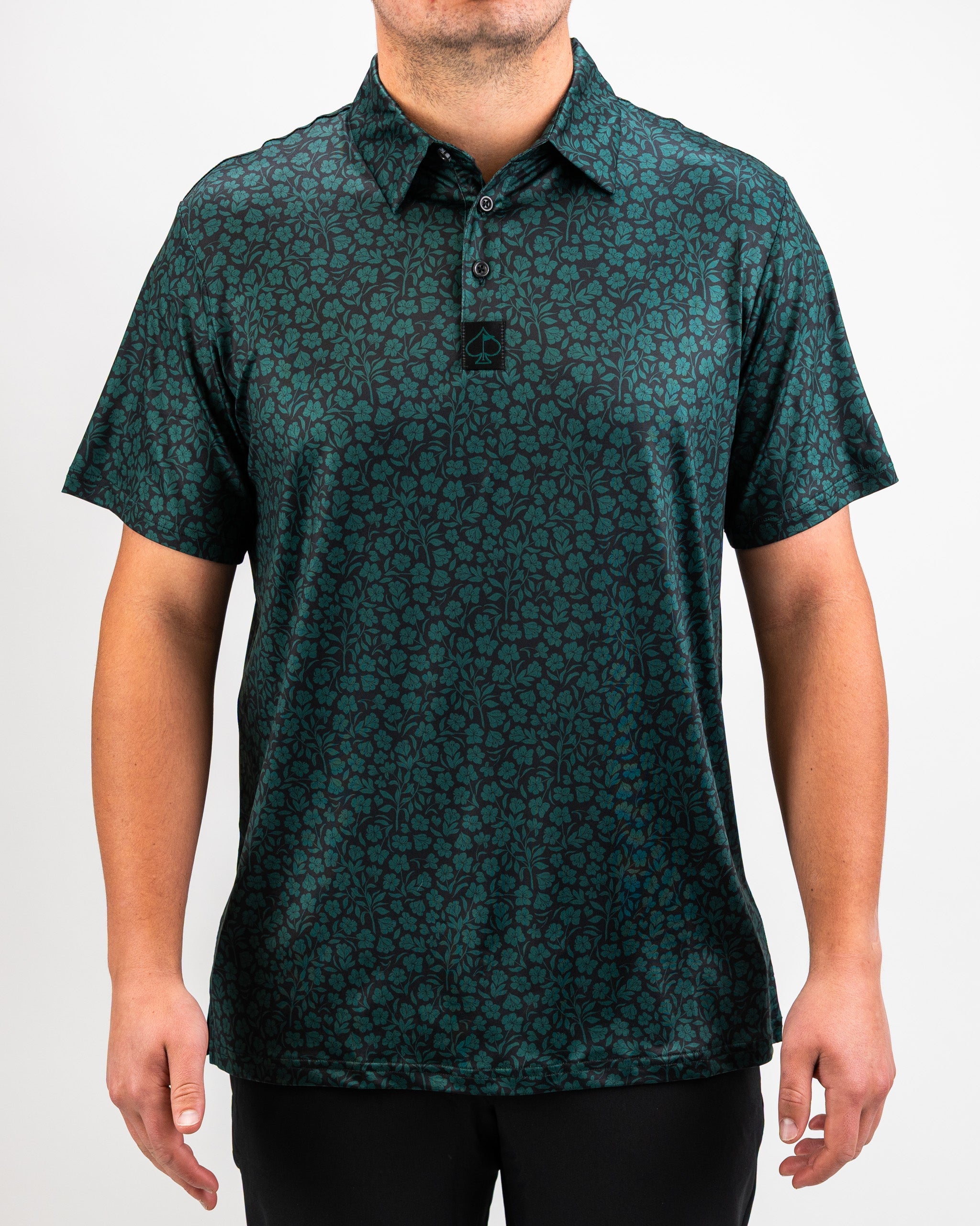 Hibiscus green shirt displayed on a light background.