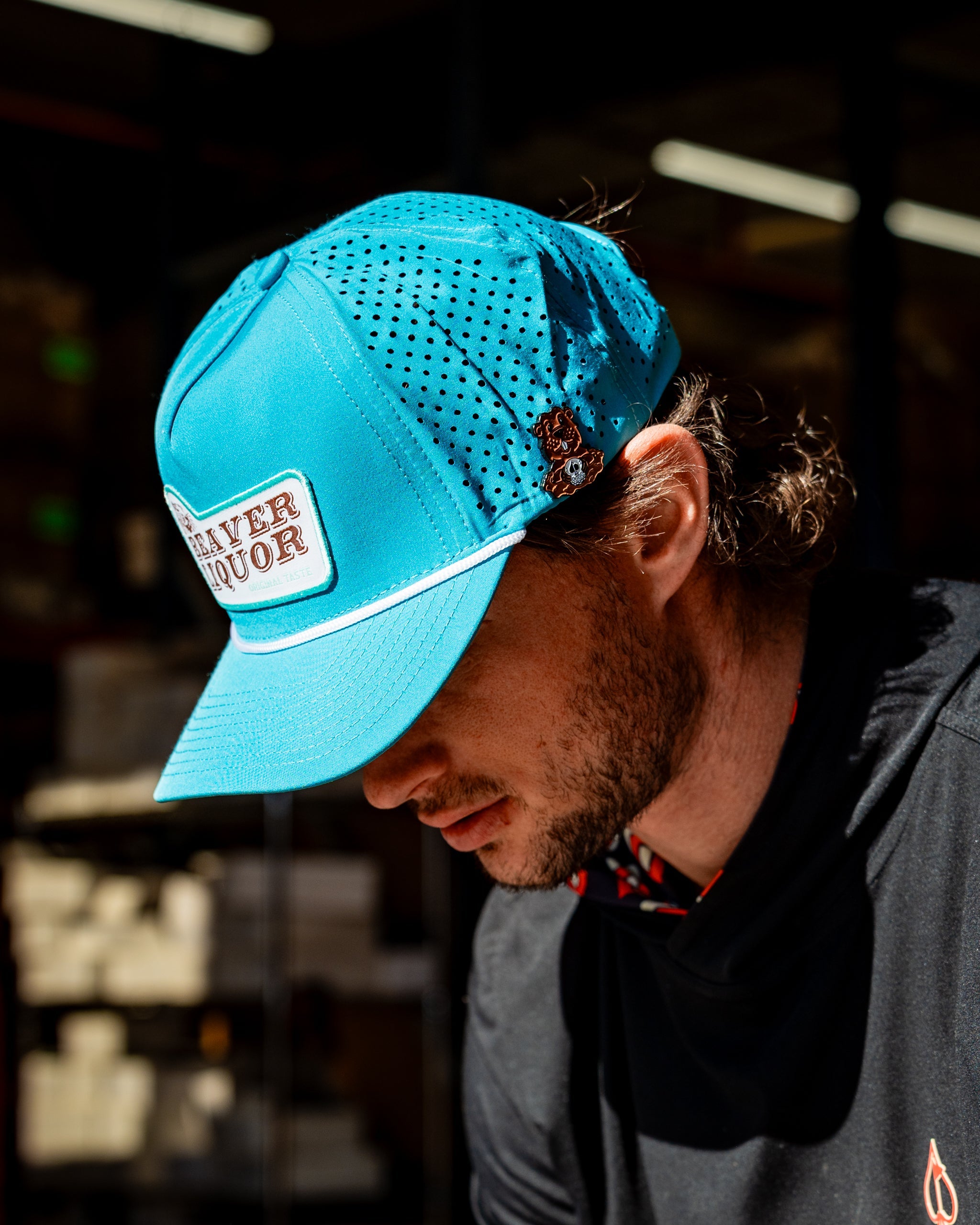 Perforated baby blue rope hat featuring Beaver Liquor logo, ideal for outdoor activities.