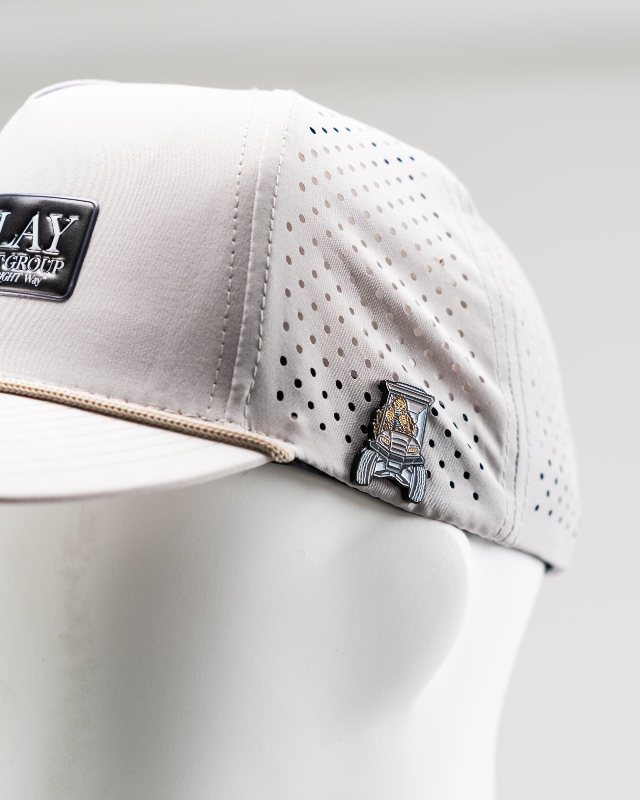 Perforated bone-colored rope hat from Parlay Investment Group, featuring a stylish design and breathable material.