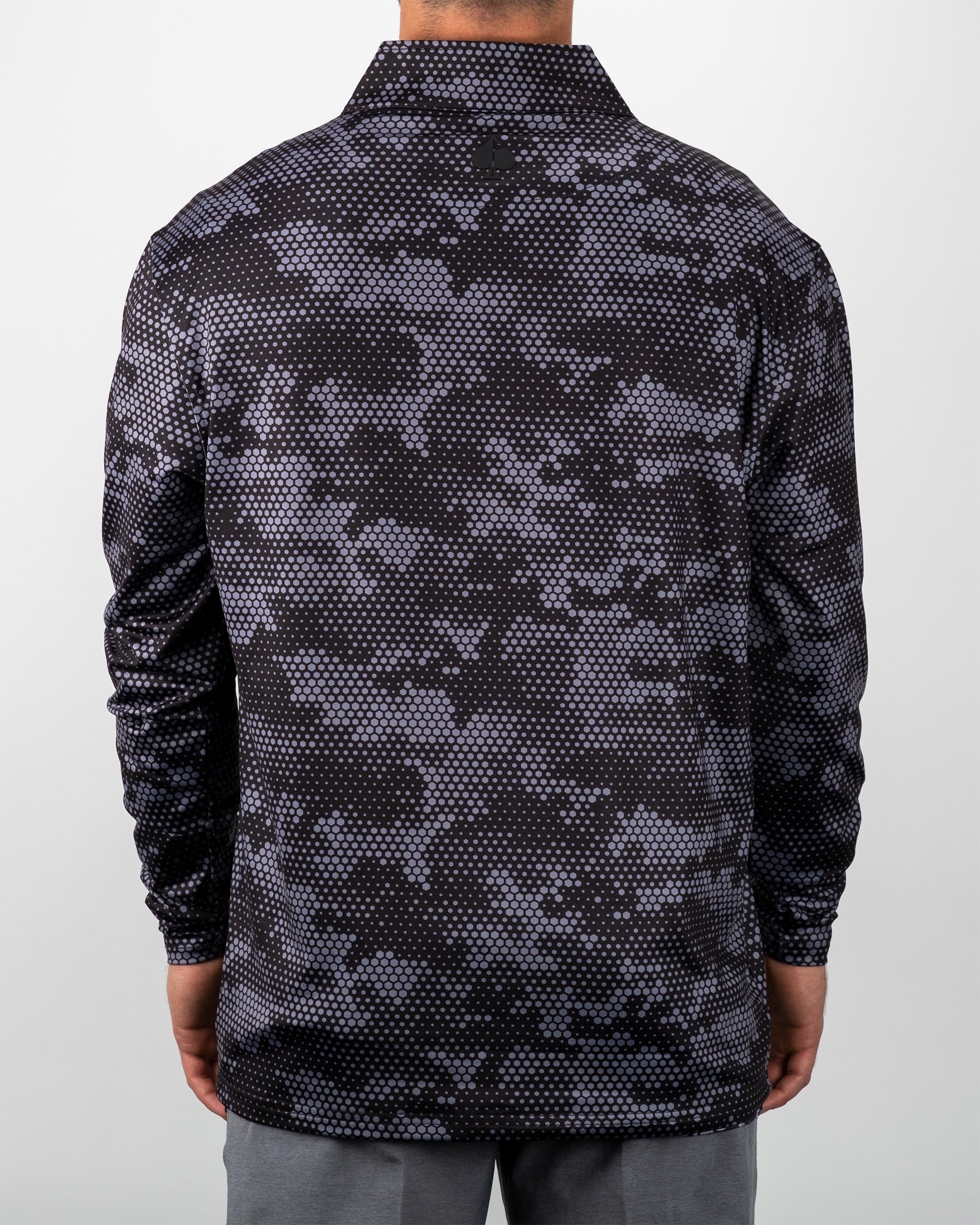 Back view of a black and purple hexagonal pattern Digi Pullover with a collar, worn by a person standing against a plain background.