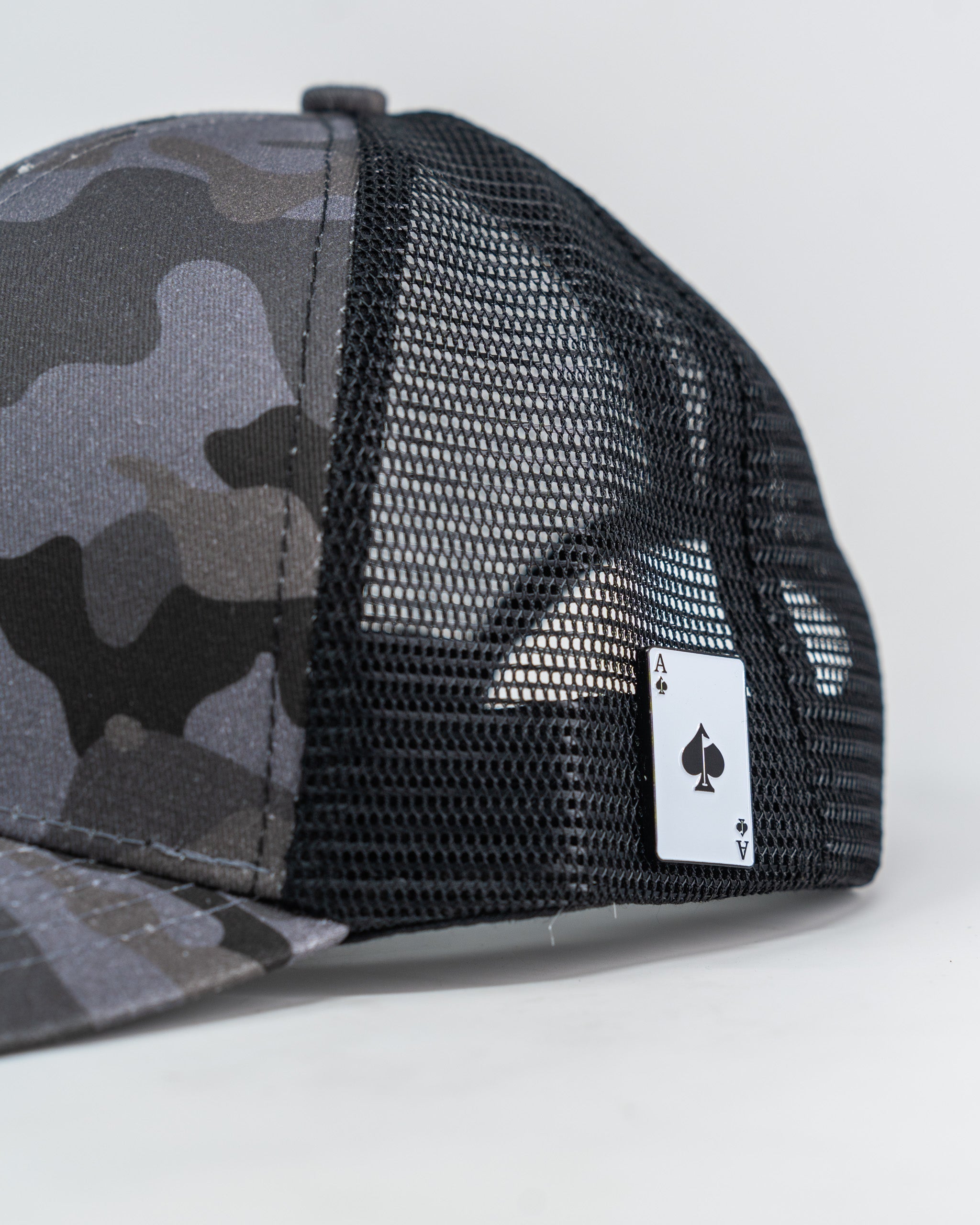 Urban camo trucker hat with mesh back and adjustable snap closure.