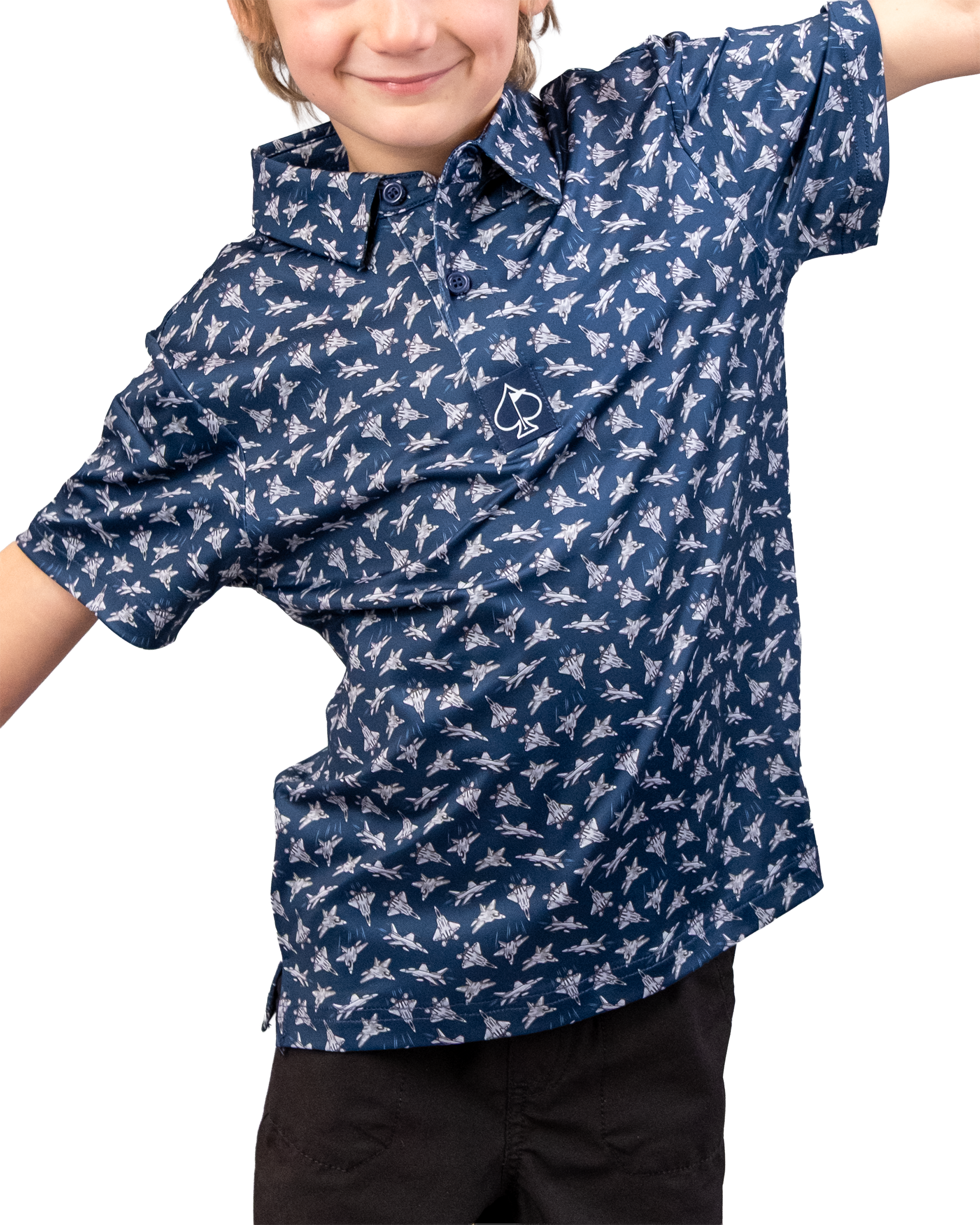 A young boy wears a navy blue golf shirt with a white bird of steel pattern and a small logo on the chest, smiling confidently.