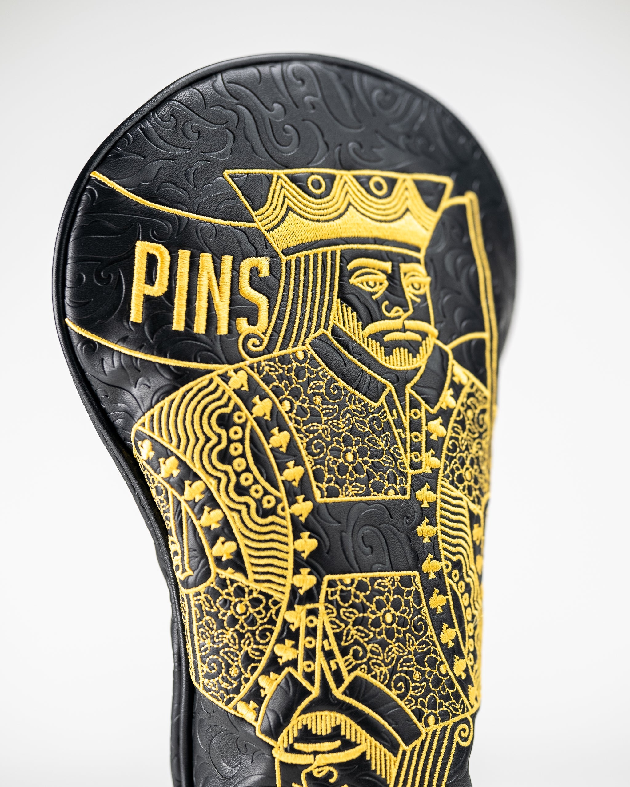 Black and gold King of Spades driver cover with a sleek design, featuring a spade symbol.