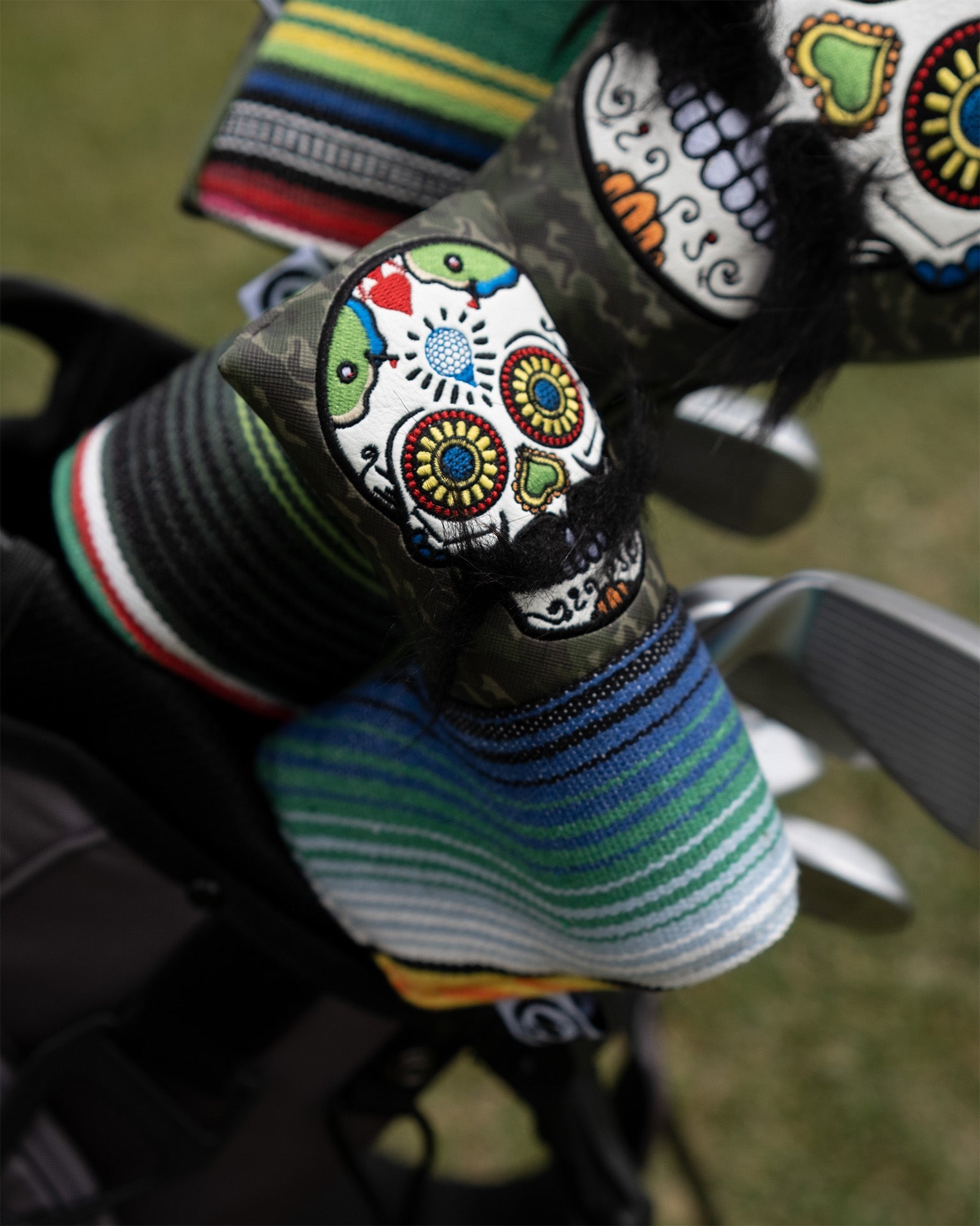 Mustache Sugar Skull Blade Putter Cover in Green Camo Design.