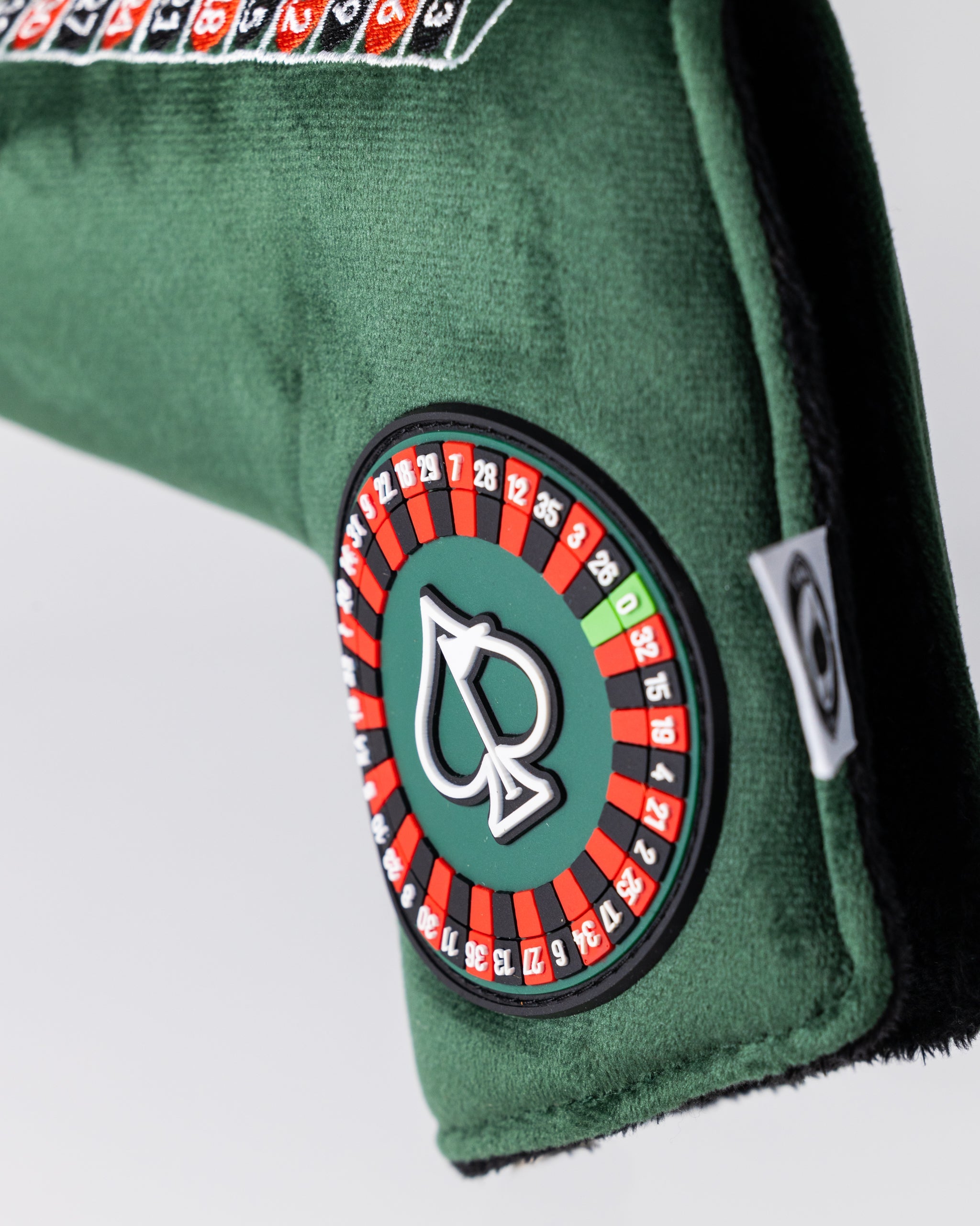 Alt text: "Roulette-themed blade putter cover featuring vibrant casino graphics."