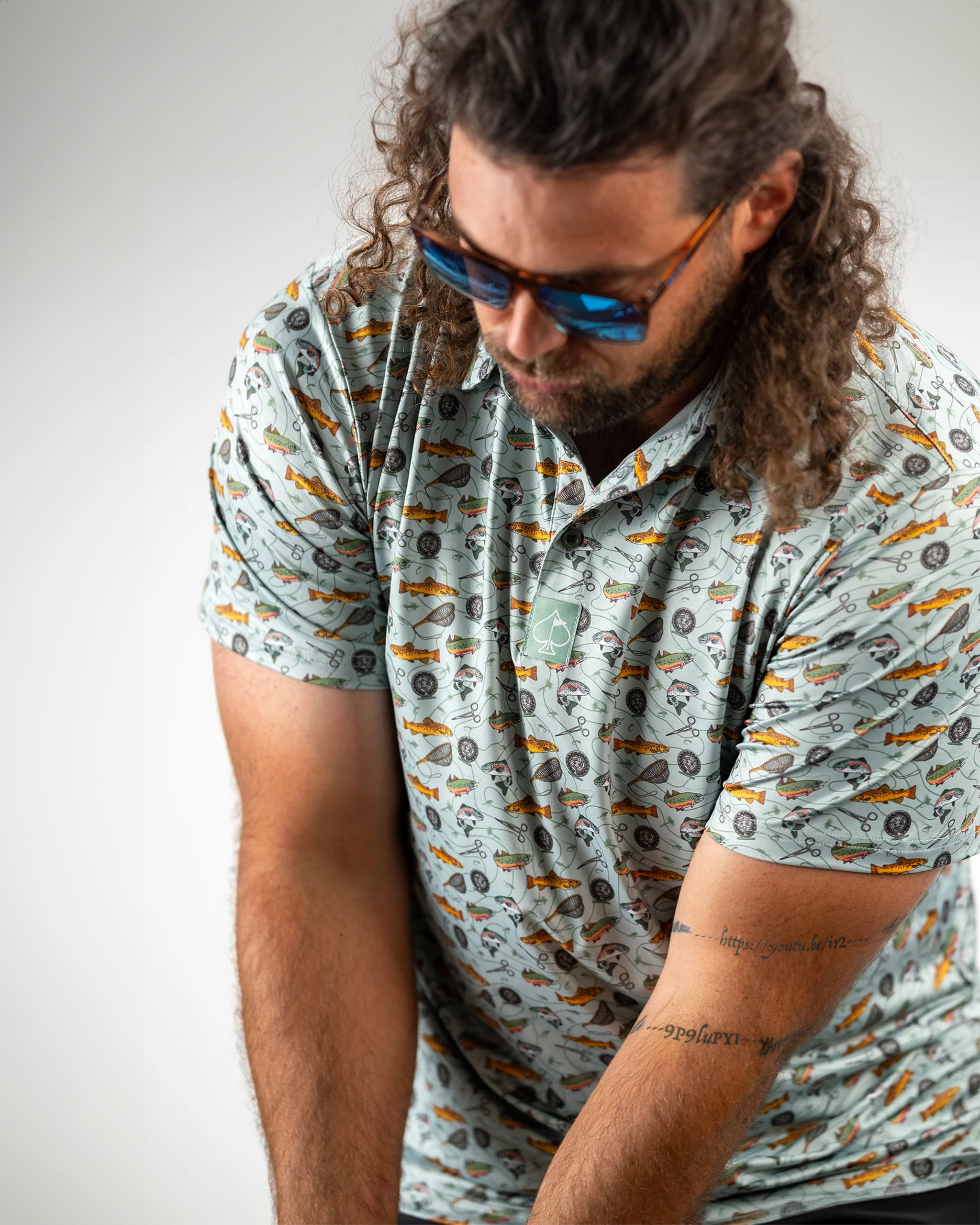 Catch and Release polo shirt featuring a graphic design of a fish, perfect for outdoor enthusiasts and fishing lovers.