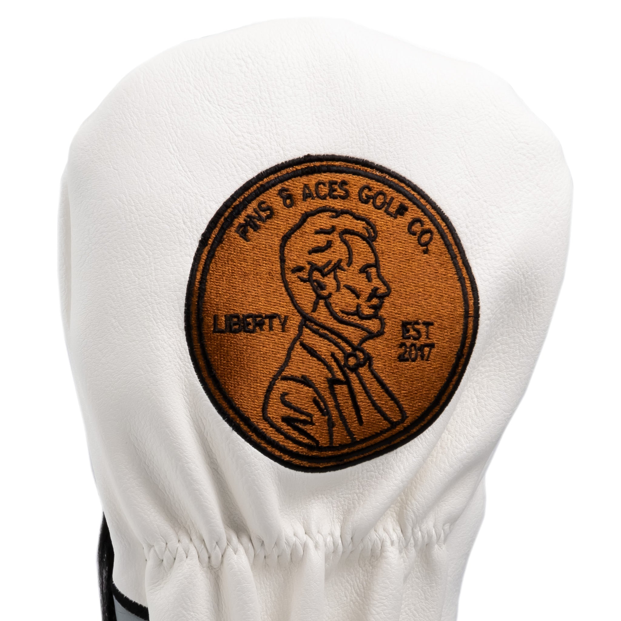 Alt text: "White leather golf club driver cover featuring an embroidered patch of Abraham Lincoln with text 'TMS & ACES GOLF CO LIBERTY EST 2017'."