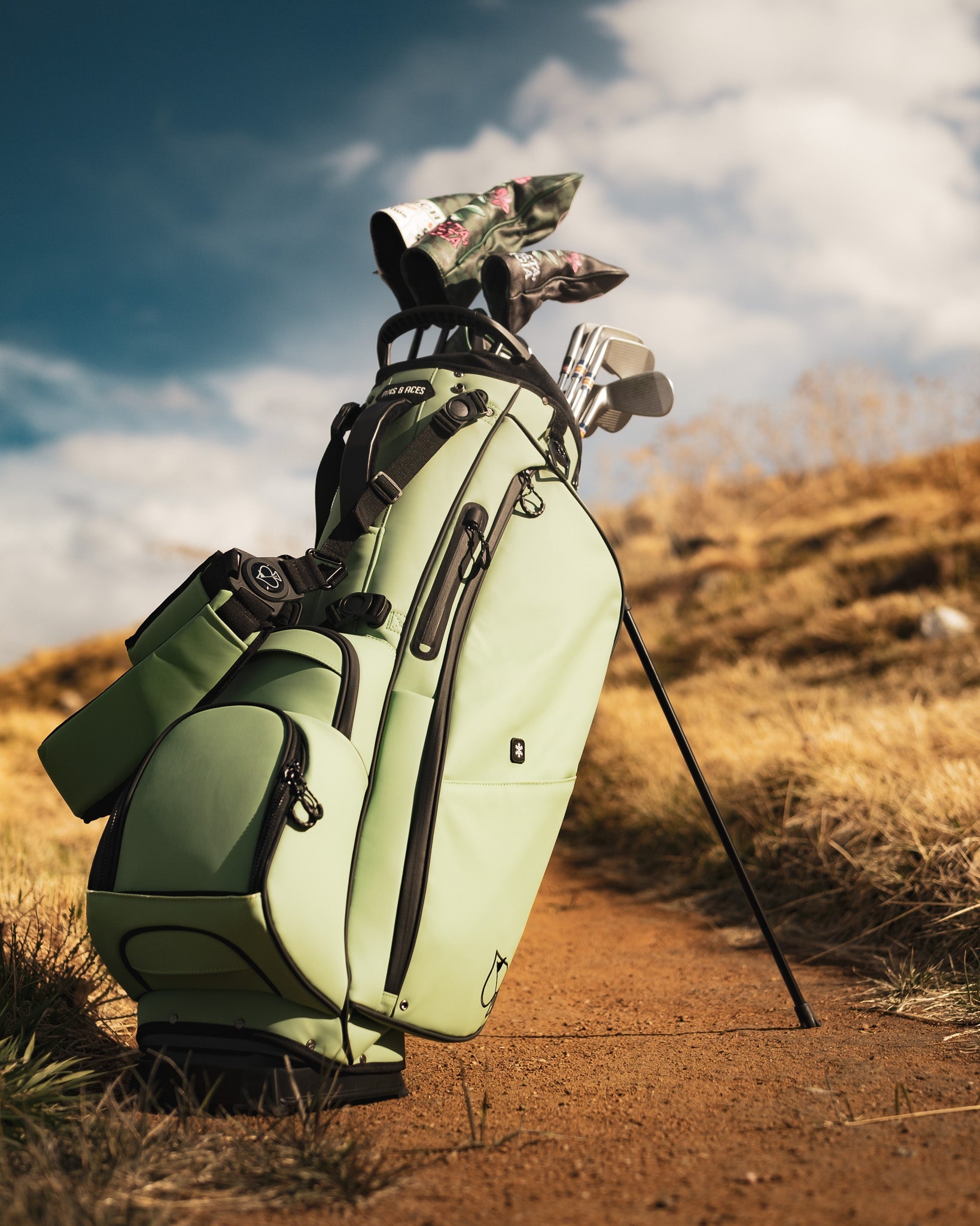 Alt text: Sage green Player Preferred™ golf bag with multiple pockets and a sturdy strap, featuring a sleek design ideal for golfers.