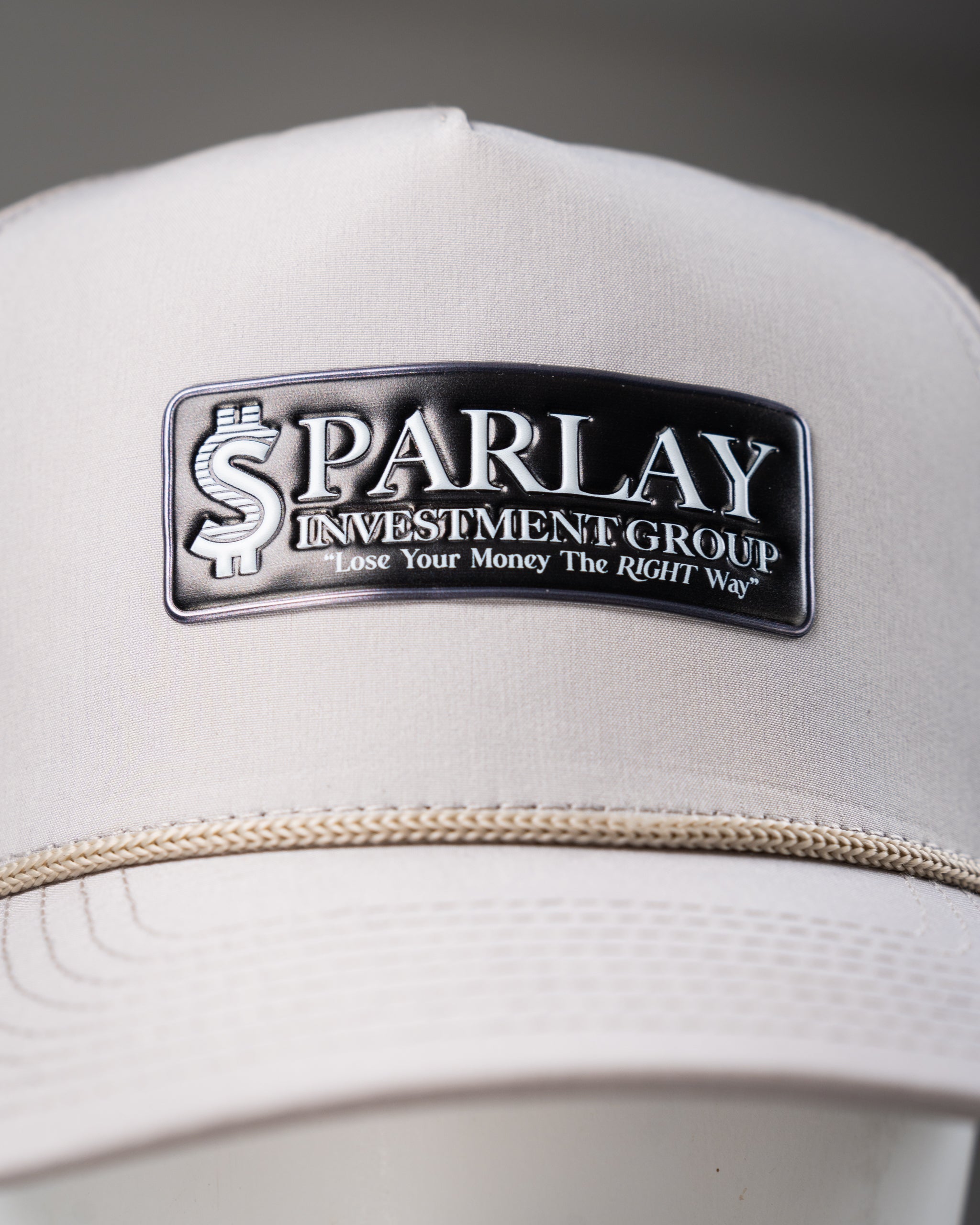 Perforated bone-colored rope hat from Parlay Investment Group, featuring a stylish design and adjustable fit.