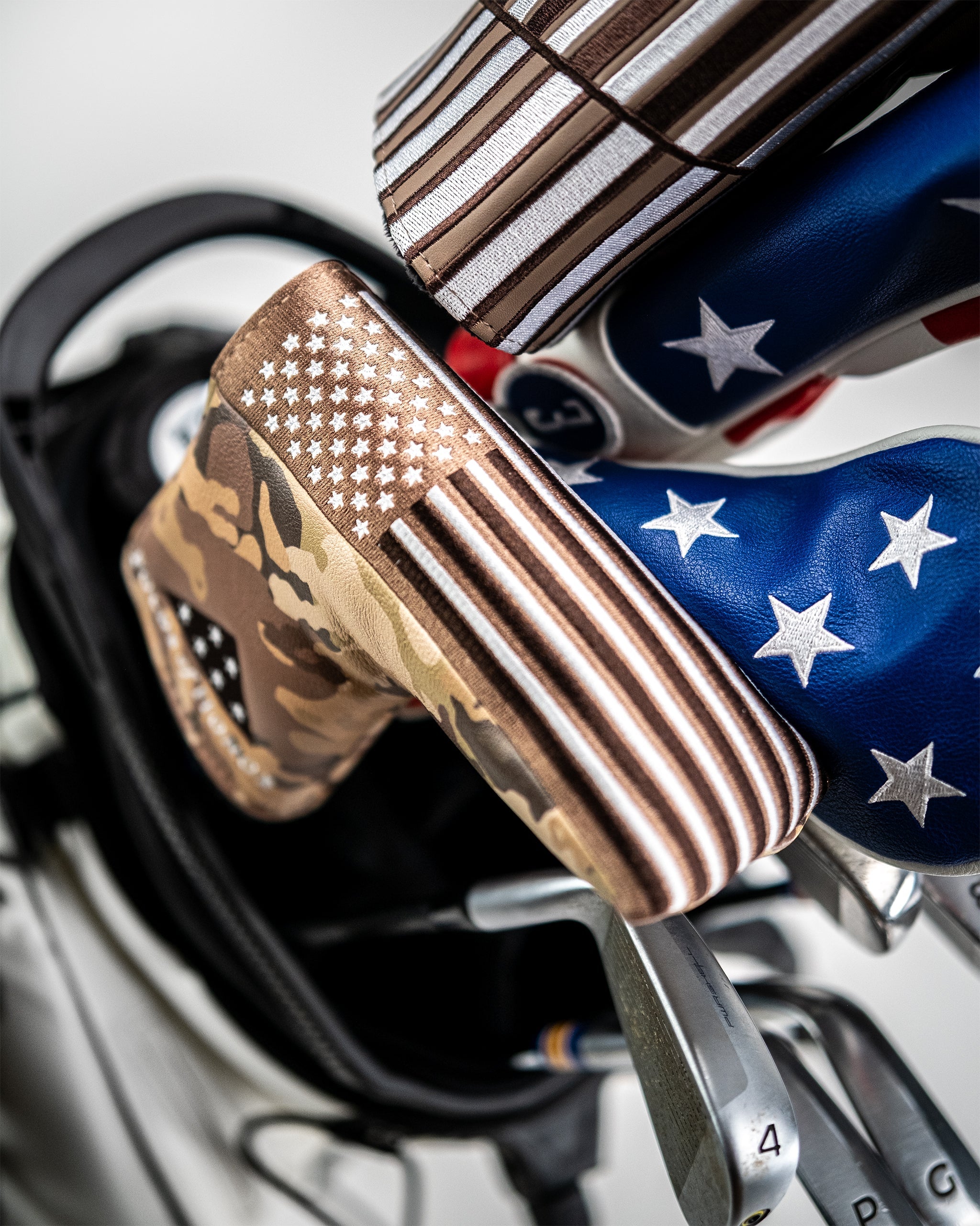 Folds of Honor 2.0 Blade Putter Cover in black with patriotic design and logo detailing.