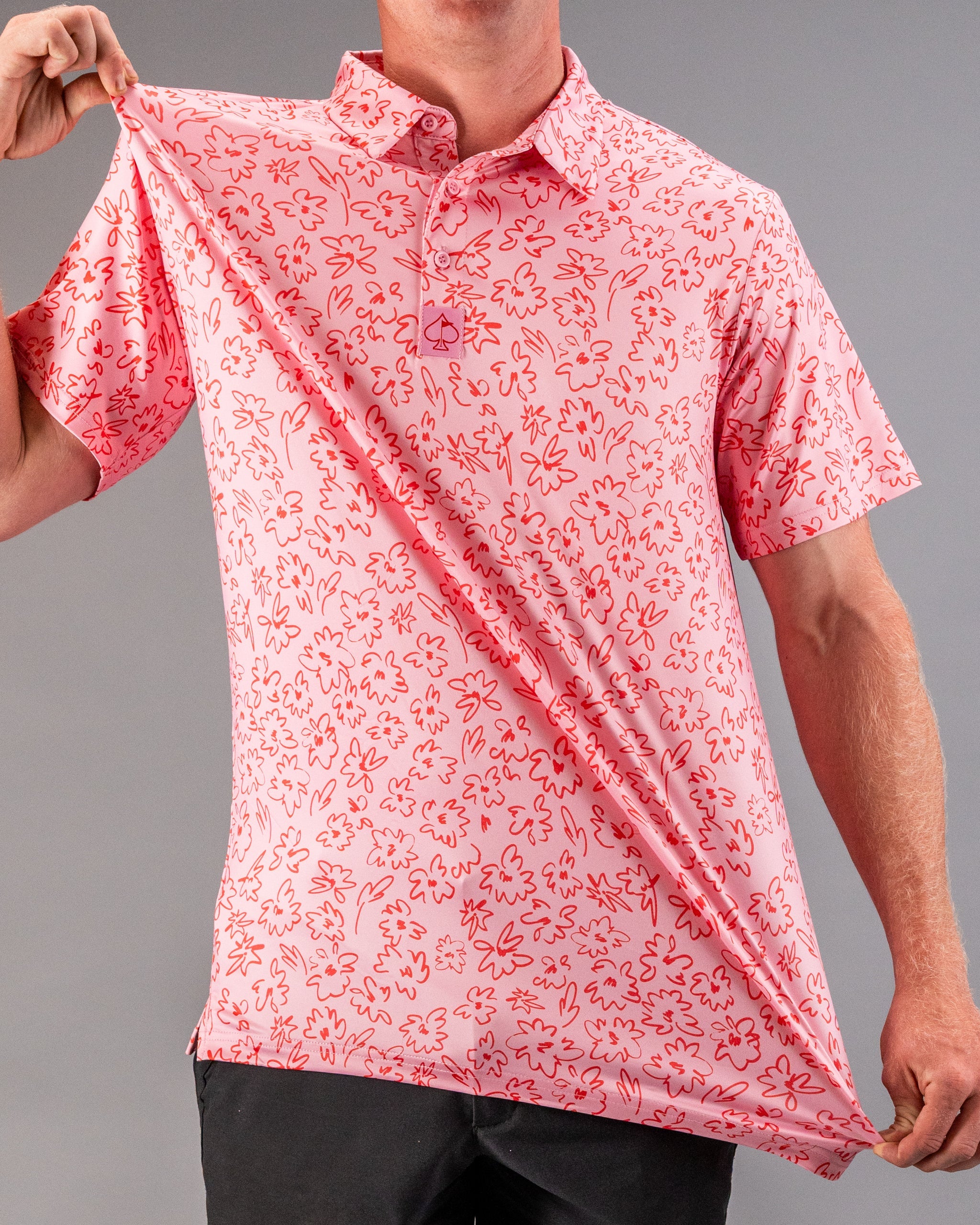 Men's pink golf polo featuring a playful flower doodle pattern, perfect for adding style on the course.