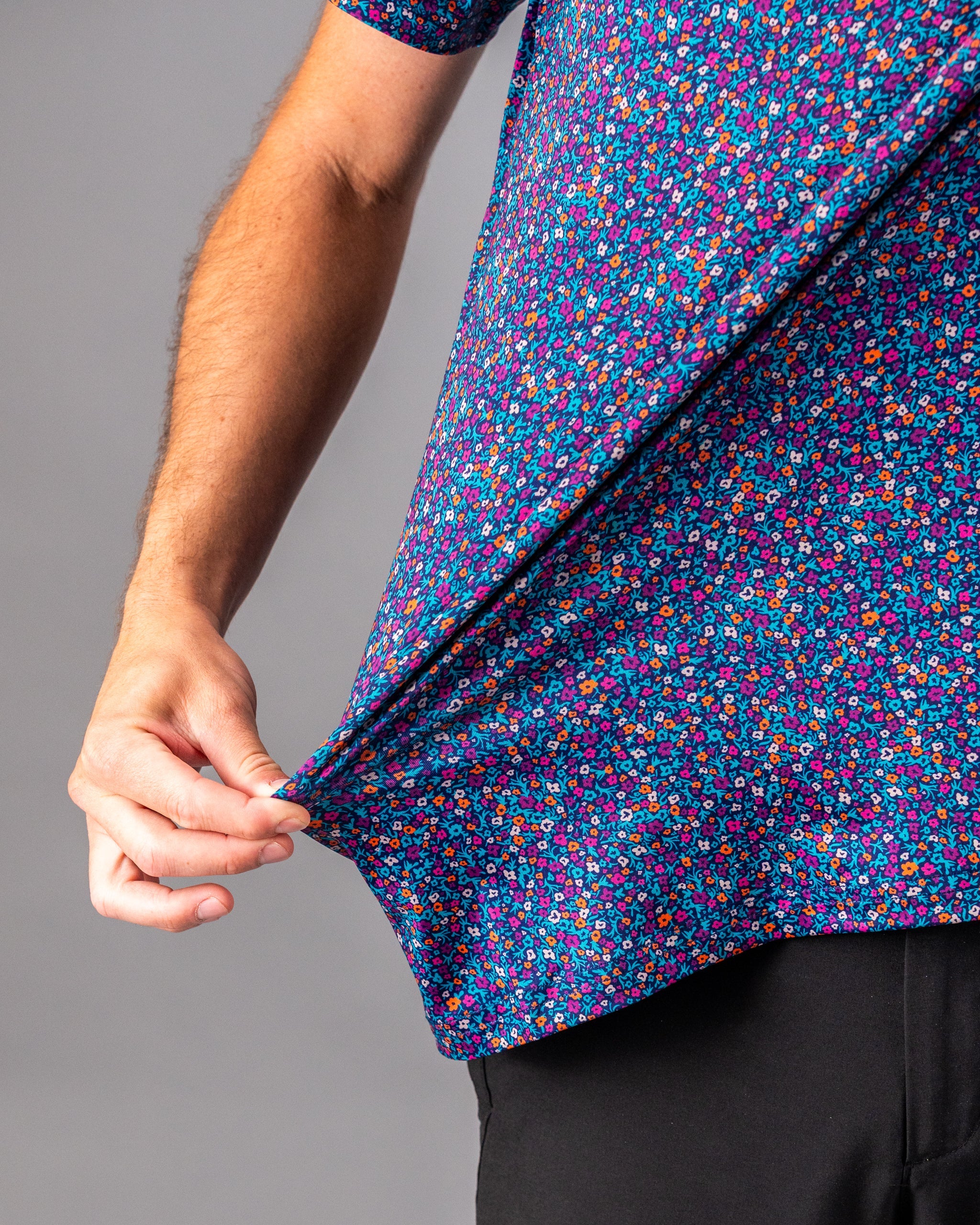 Bold golf shirt featuring a vibrant lavender floral pattern, showcasing a close-up of the fabric and fit.