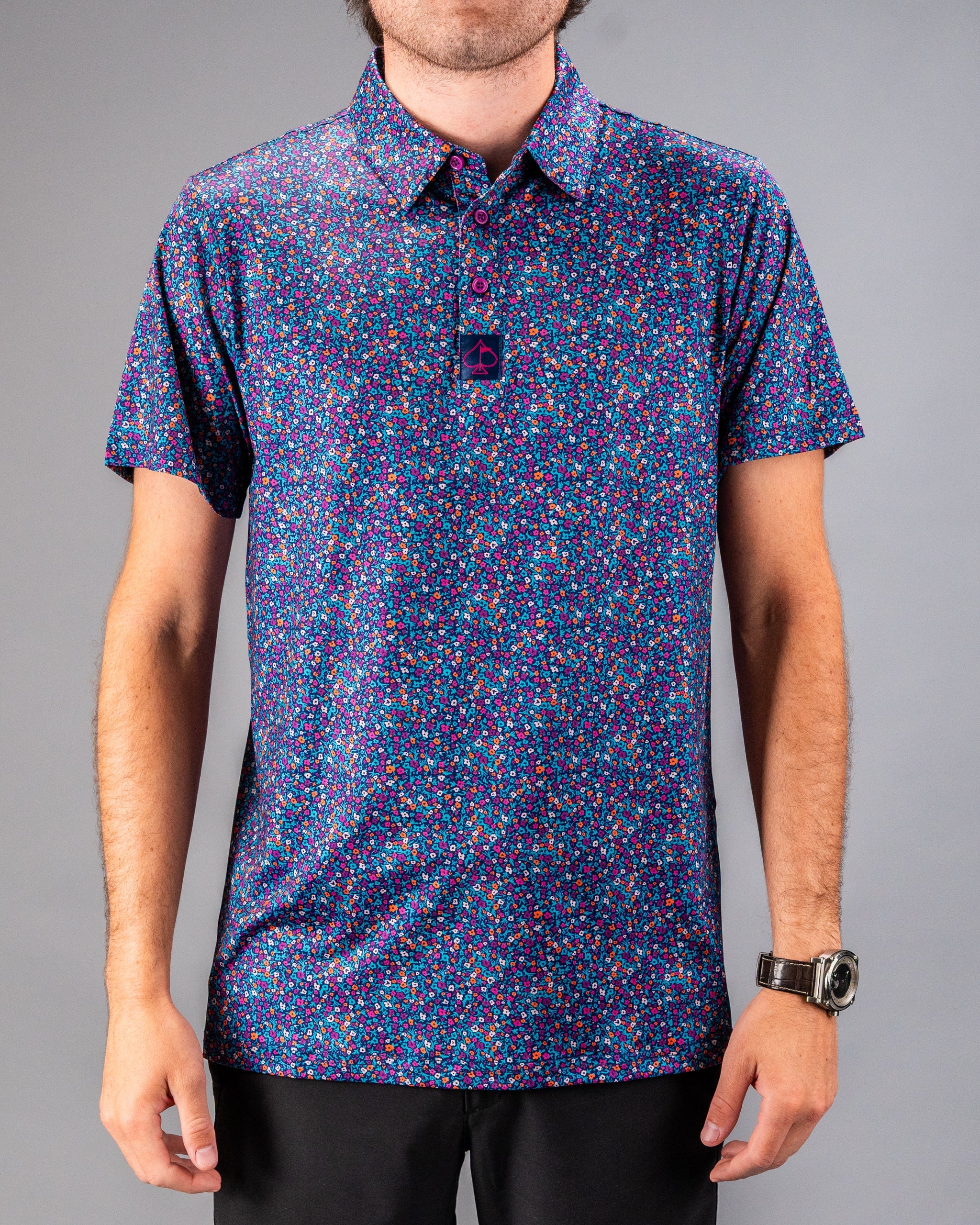 Men's golf shirt featuring a vibrant lavender floral pattern, designed for style and comfort on the course.