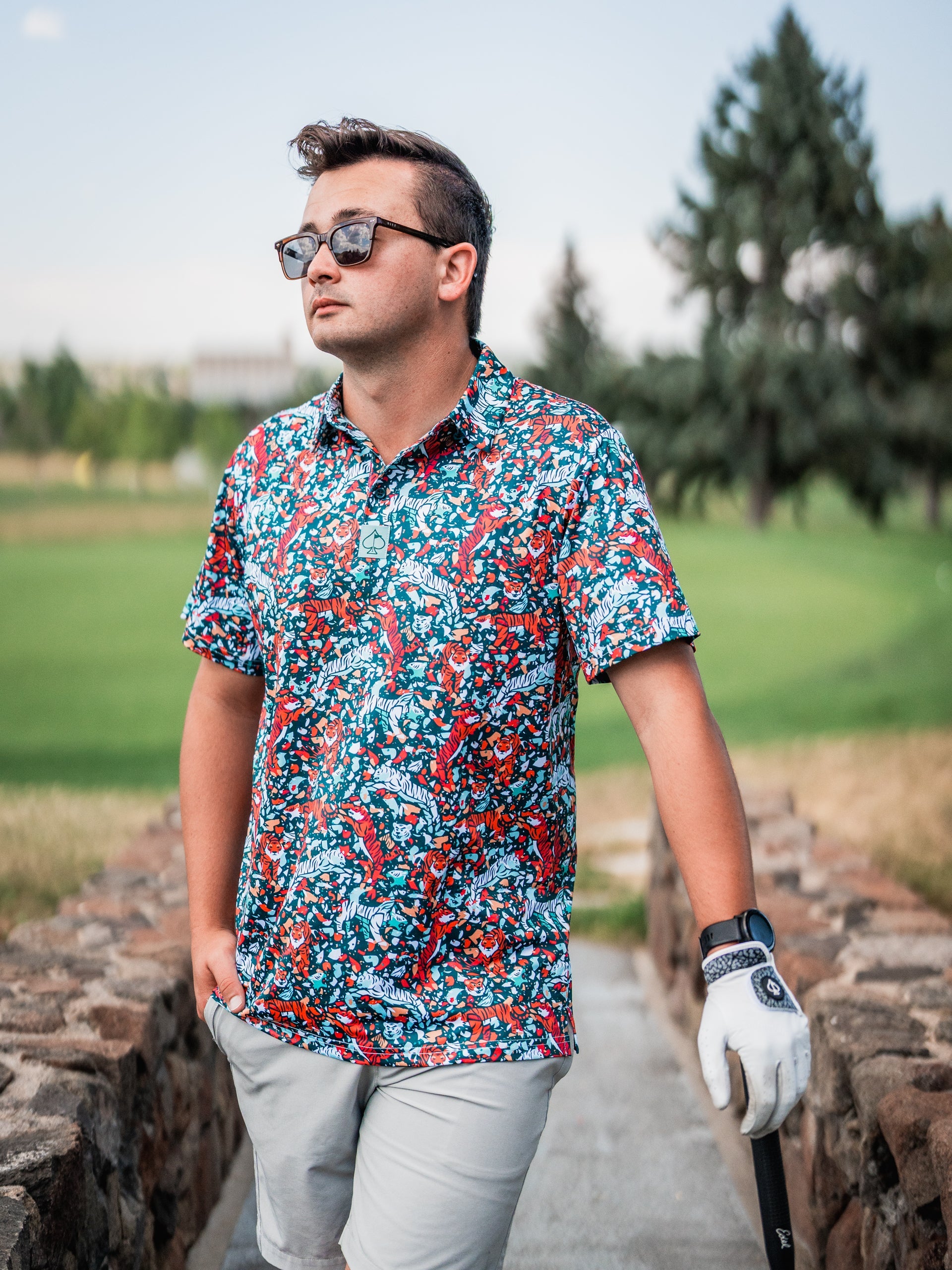 Bold Tiger Shatter Teal golf shirt featuring a vibrant, colorful pattern, perfect for making a statement on the course.