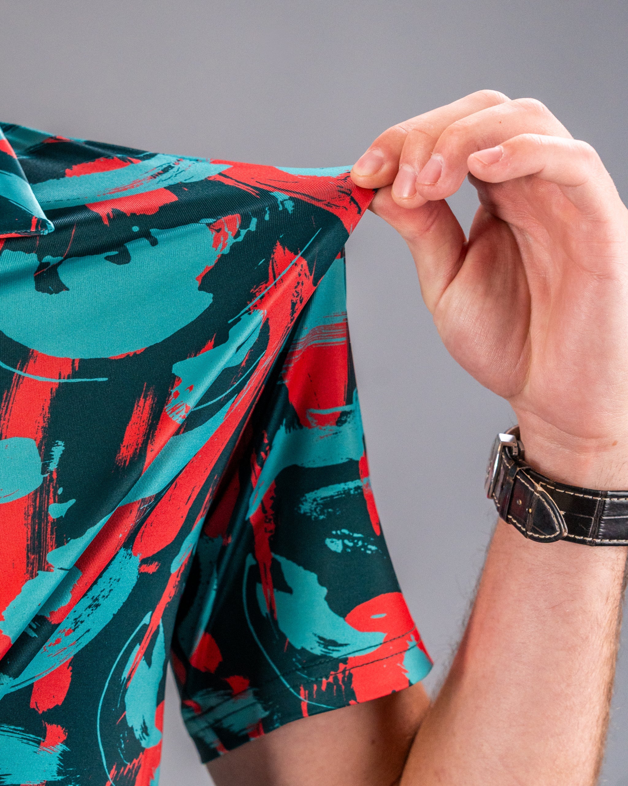 Bold Paint Strokes Coral golf shirt featuring vibrant colors and abstract patterns, perfect for stylish golfers.