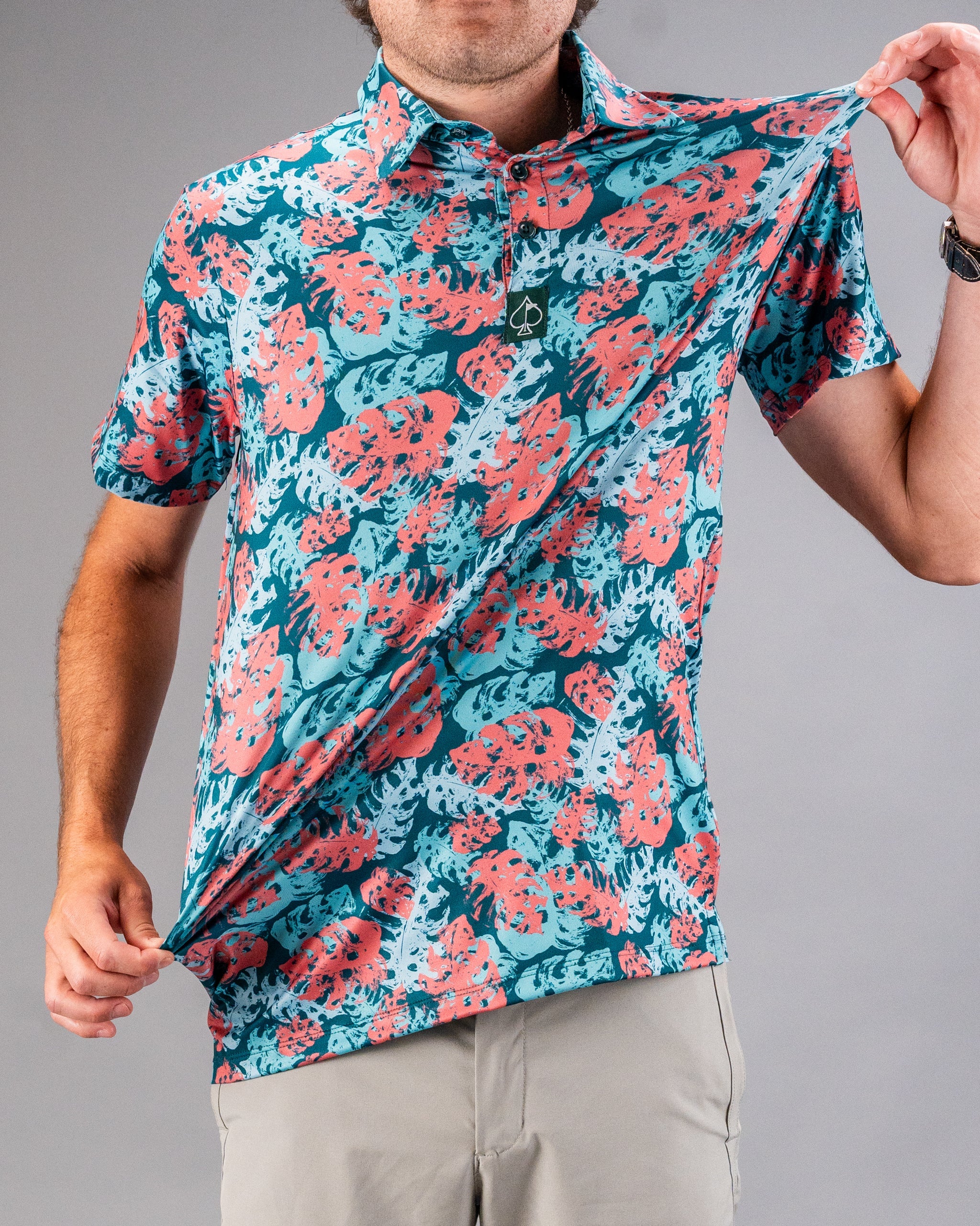 Bright blue and coral floral golf shirt with bold, tropical print for golfers who want to stand out on the course.