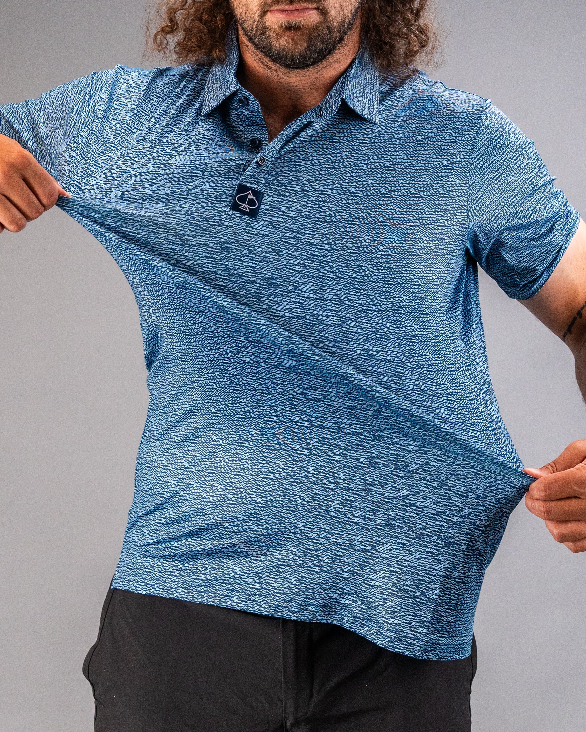Men's blue polo shirt featuring a unique squiggle pattern, perfect for golfers seeking bold style on the course.