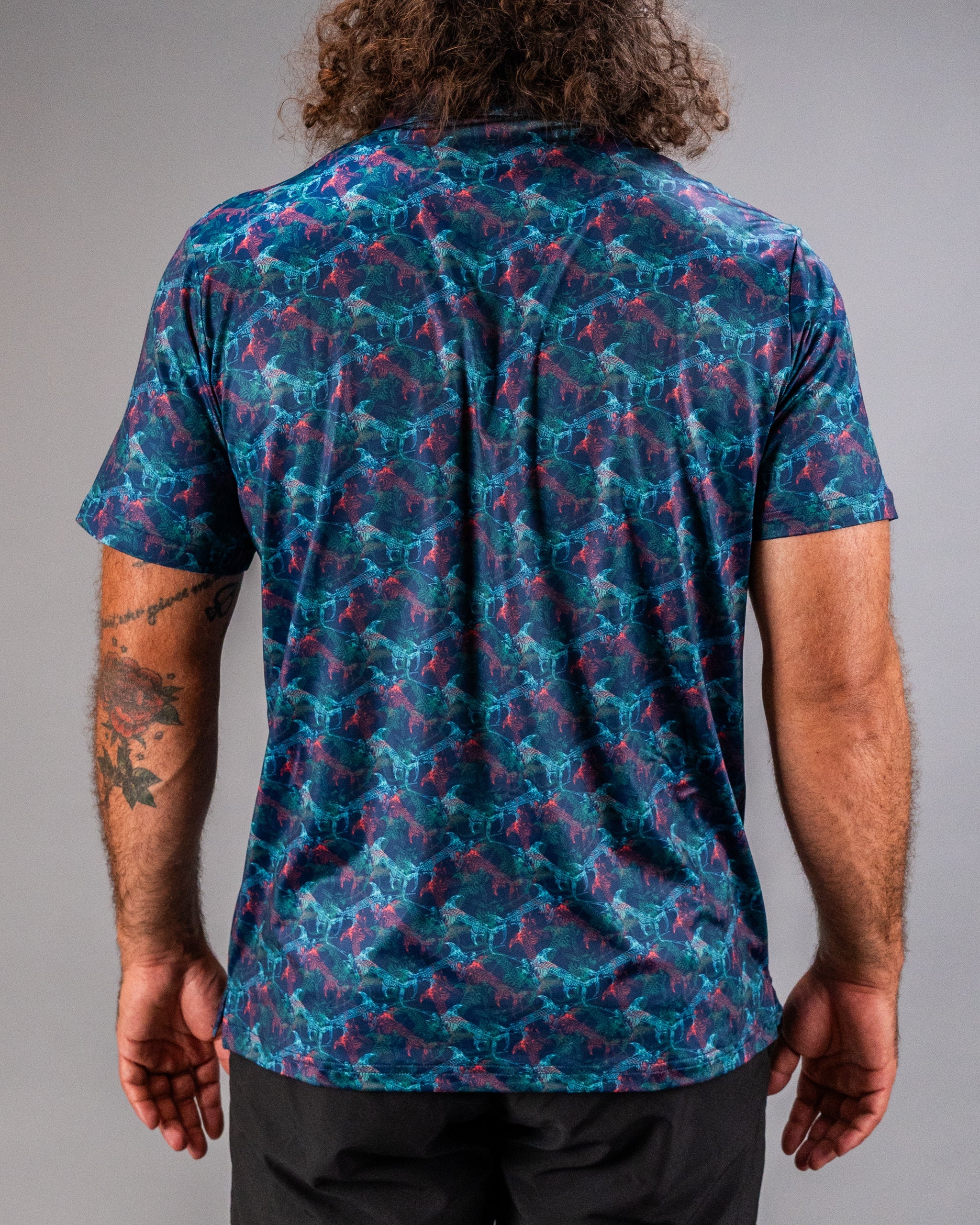 Men's Swordfish Skelly golf shirt featuring a vibrant, colorful fish pattern on a dark background, perfect for stylish golfers.