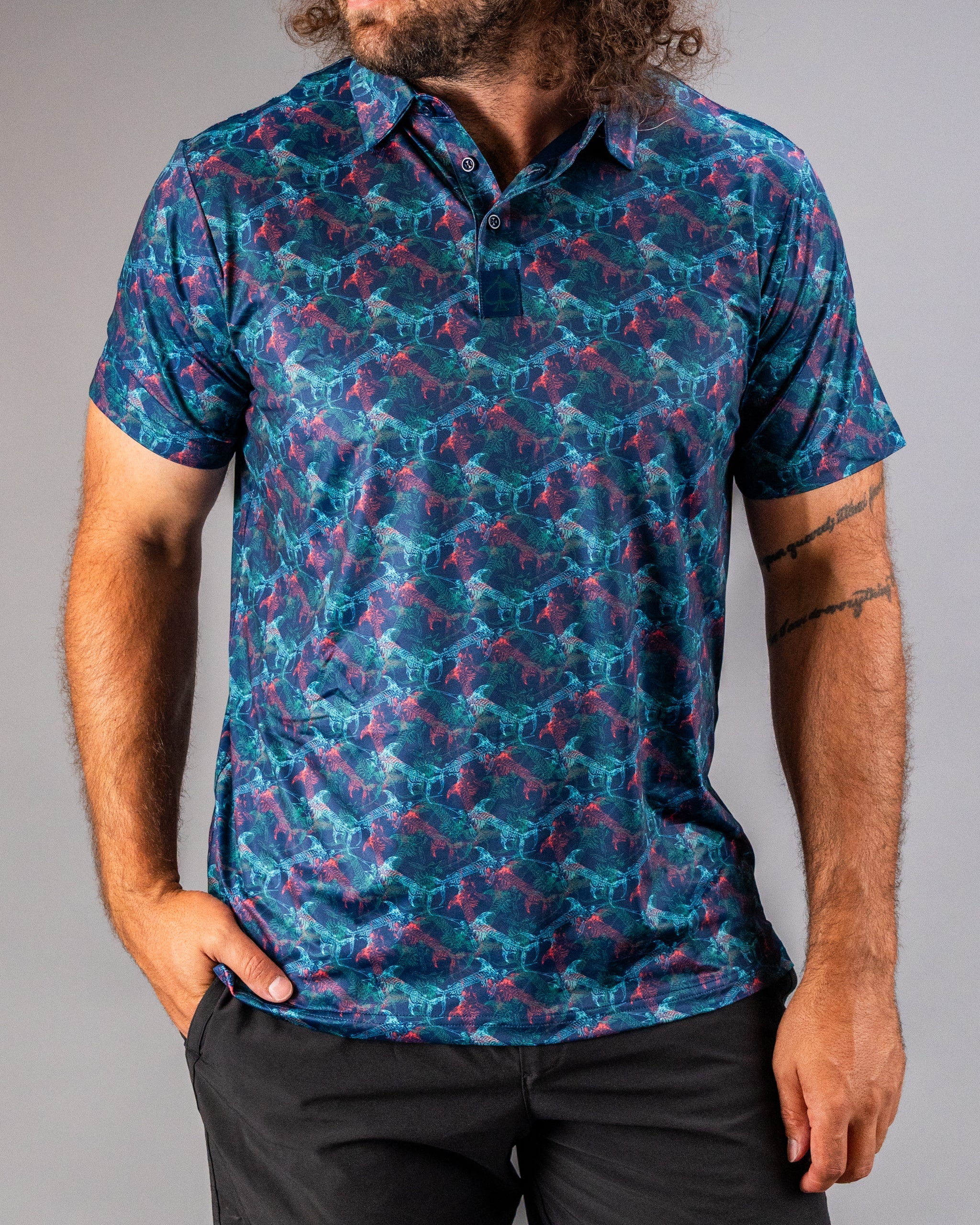 Men's short-sleeve polo featuring a vibrant swordfish pattern in blue and pink tones, perfect for stylish golf outings.