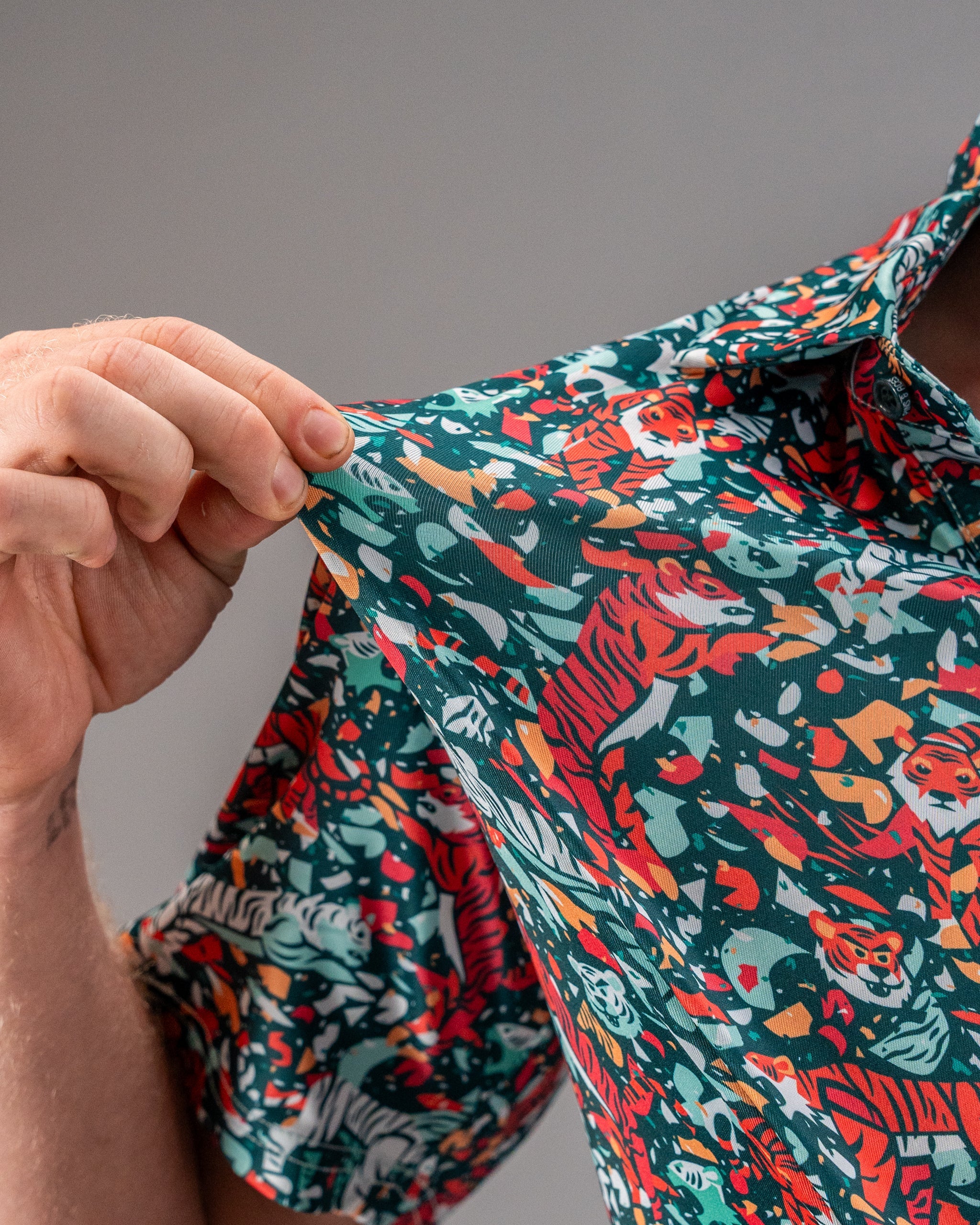 Bold teal golf shirt featuring a vibrant tiger print, perfect for golfers looking to make a statement on the course.