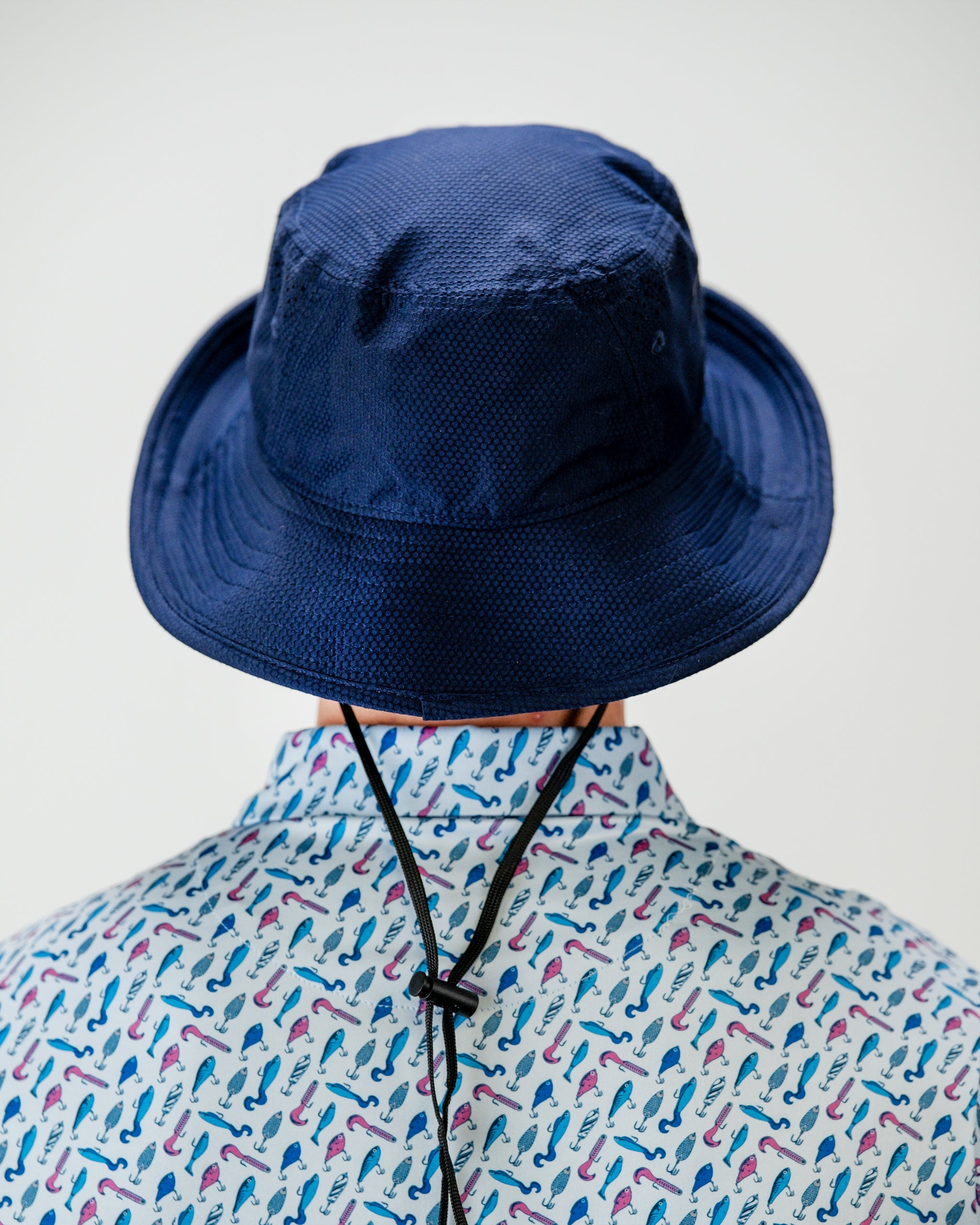 Catch & Release Bucket Hat featuring a vibrant fish design on a light background.
