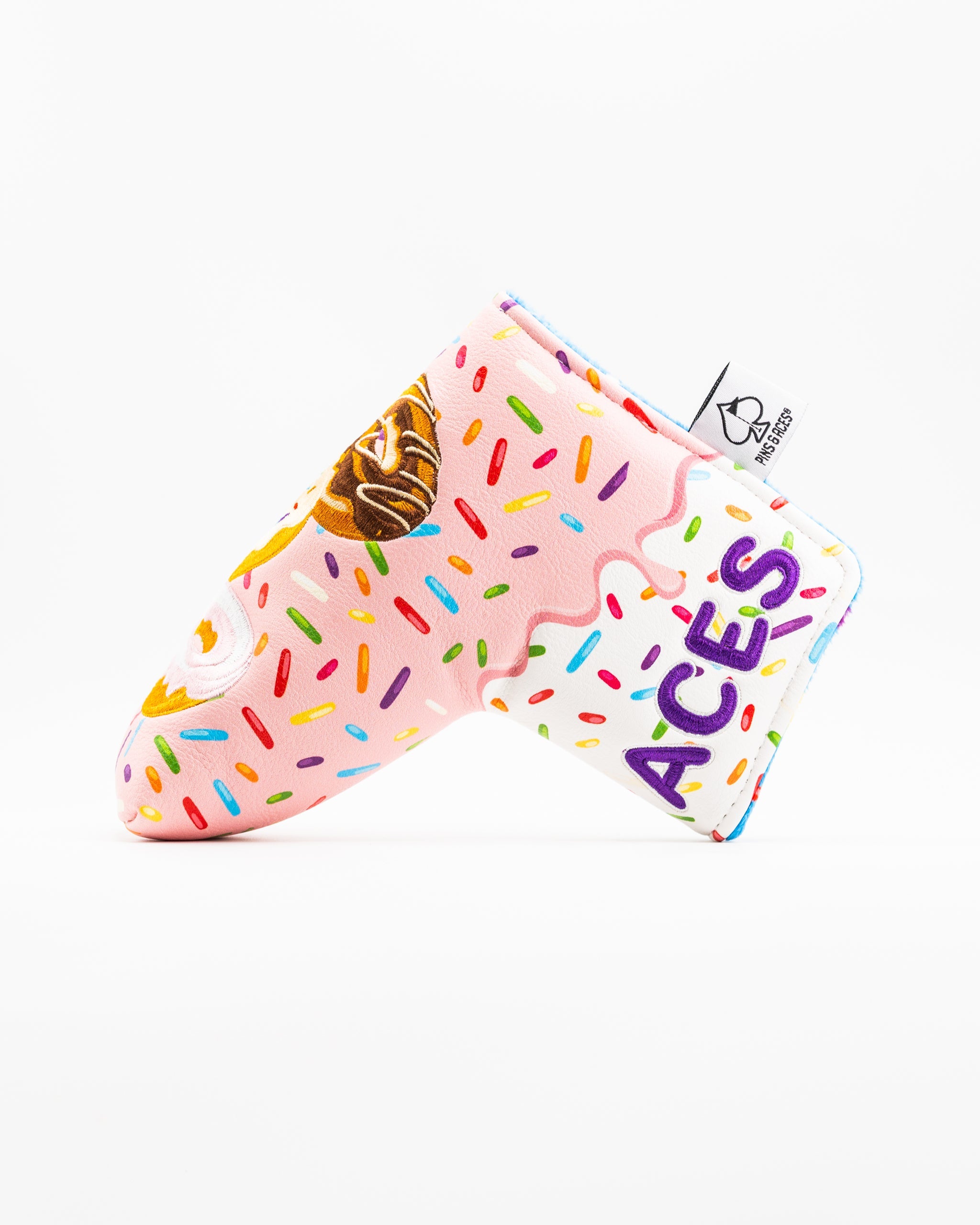 Colorful blade putter cover featuring a donut design with sprinkles and the word "ACES" prominently displayed.